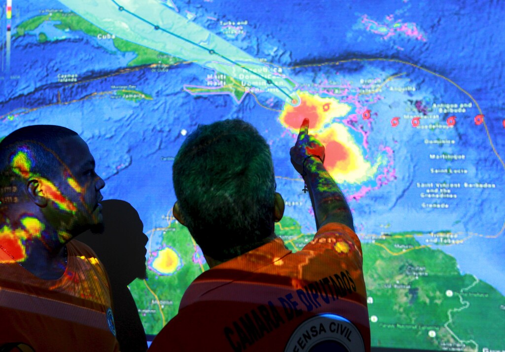 Members of the Emergency Operations Committee (COE) monitor the trayectory of Tropical Storm Erika via satellite in Santo Domingo, August 28, 2015. Tropical Storm Erika threatened Haiti and the Dominican Republic with heavy rain and strong winds on Friday as it swirled across the Caribbean and geared up for a run at South Florida, the U.S. National Hurricane Center said. Due to some likely weakening over mountainous areas, Erika was no longer forecast to make U.S. landfall as a hurricane. REUTERS/Ricardo Rojas - GF10000185479