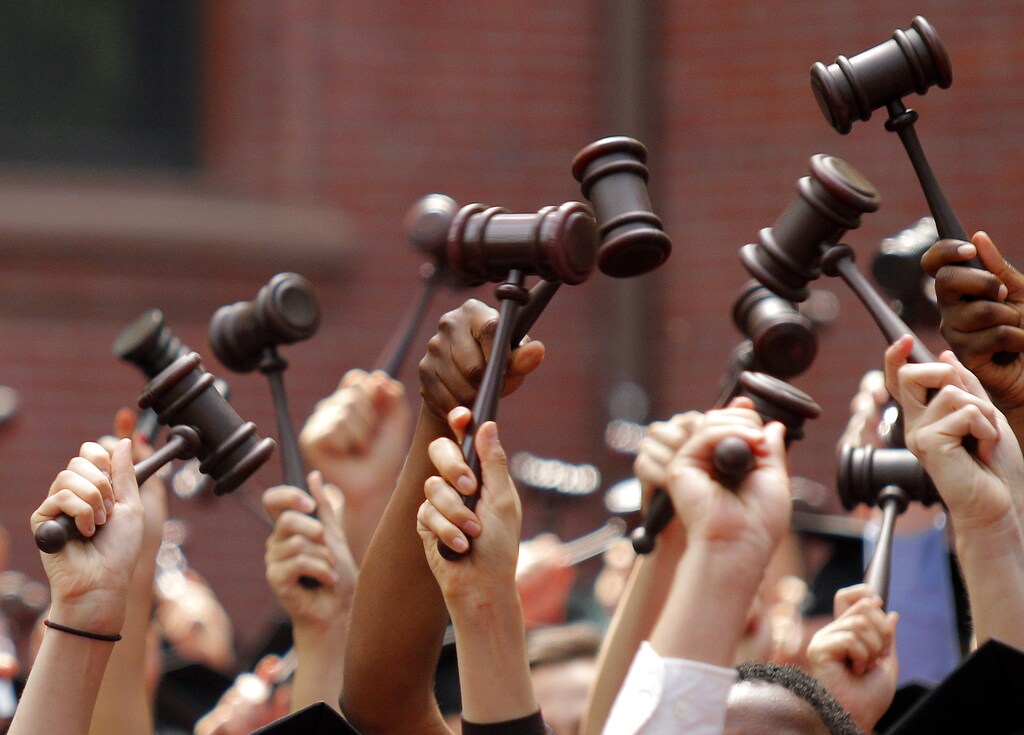 Graduates from the law school hold up gavels in celebration during their commencement at Harvard University in Cambridge, Massachusetts May 27, 2010. REUTERS/Adam Hunger (UNITED STATES - Tags: EDUCATION IMAGES OF THE DAY) - GM1E65S078Q01