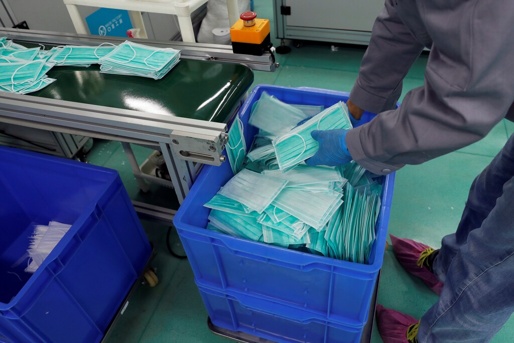 A worker works on a production line for prototype face masks at Mask Factory, following the outbreak of the new coronavirus, in Hong Kong, China Coronavirus china virus health healthcare who world health organization disease deaths pandemic epidemic worries concerns Health virus contagious contagion viruses diseases disease lab laboratory doctor health dr nurse medical medicine drugs vaccines vaccinations inoculations technology testing test medicinal biotechnology biotech biology chemistry physics microscope research influenza flu cold common cold bug risk