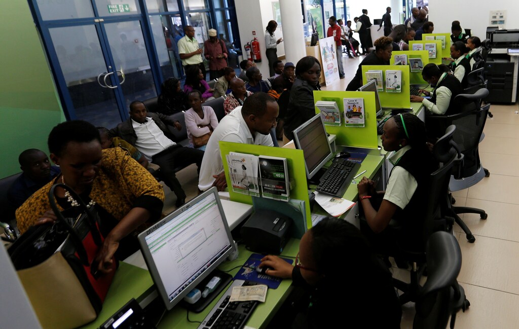Employees serve customers inside a mobile phone care centre operated by Kenyan's telecom operator Safaricom in the central business district of Kenya's capital Nairobi, May 11, 2016.