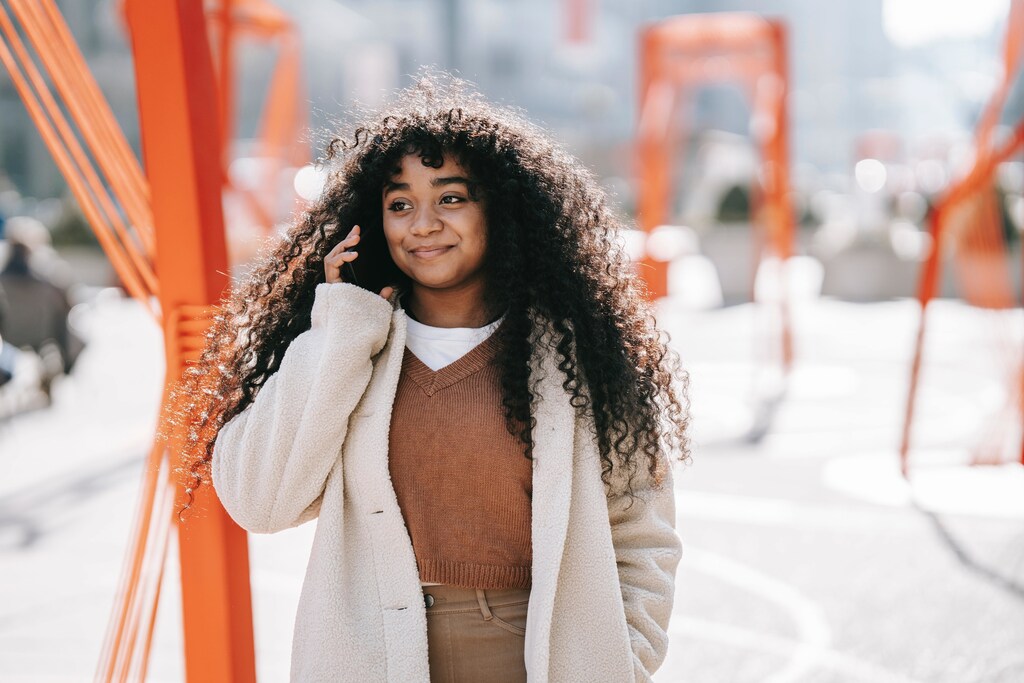 A happy young woman speaking on the phone