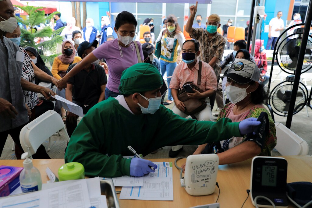 Booster vaccination program for the general public amid the rise of the Omicron variant in Jakarta.