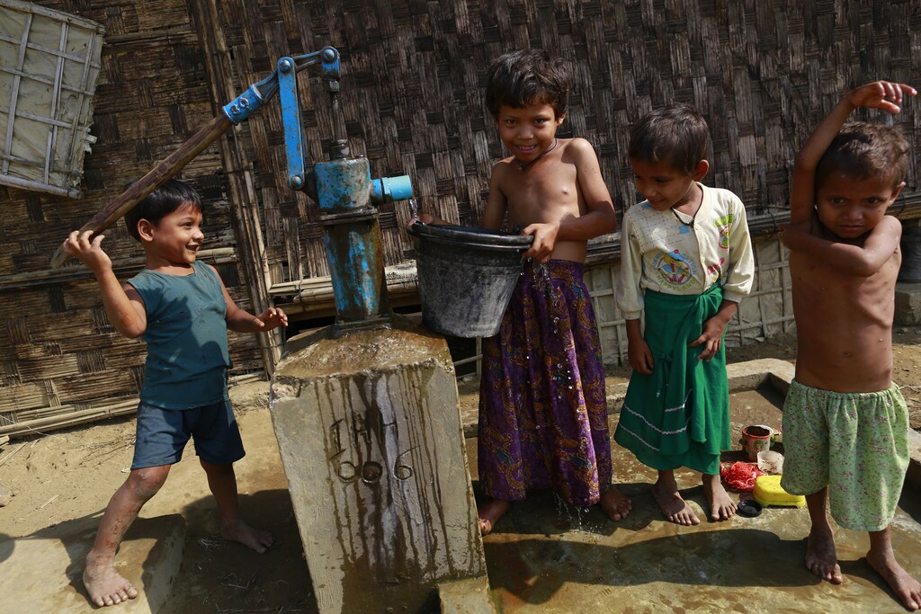 Rohingya children collect water at a refugee camp outside Sittwe, March 2014.