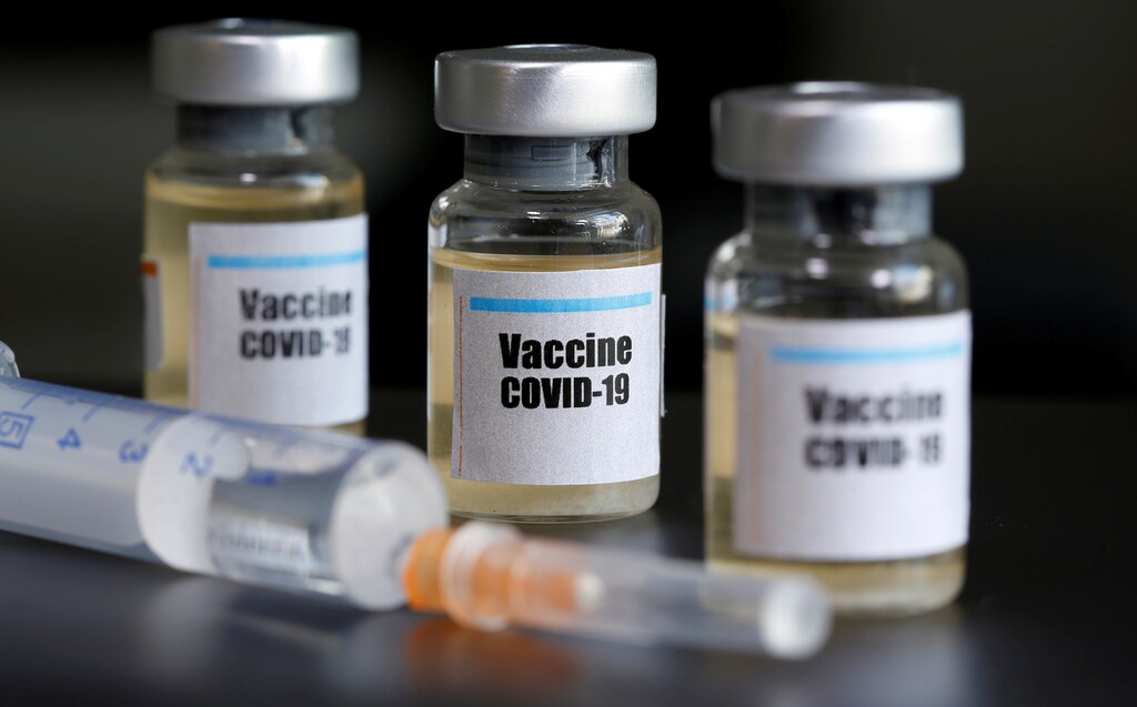 Small bottles labeled with a "Vaccine COVID-19" sticker and a medical syringe are seen in this illustration taken taken April 10, 2020. REUTERS/Dado Ruvic/Illustration - RC2M1G9O1B56