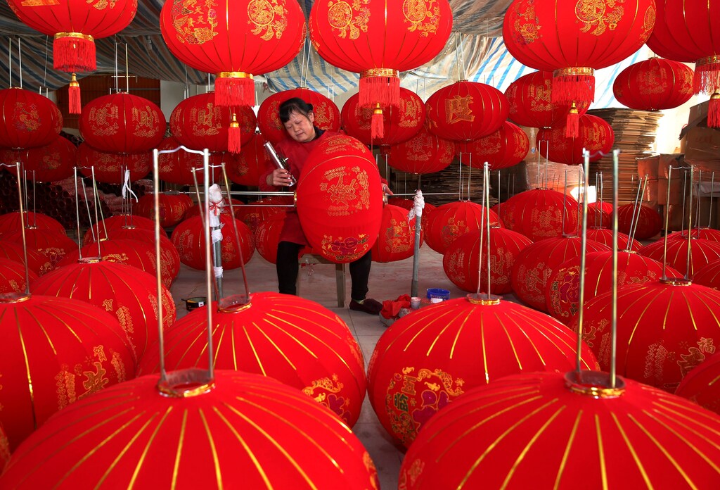 A villager makes red lanterns at a workshop in Anqing, Anhui province, China December 11, 2019. Picture taken December 11, 2019. China Daily via REUTERS ATTENTION EDITORS - THIS IMAGE WAS PROVIDED BY A THIRD PARTY. CHINA OUT. - RC2KTD9YSLGG