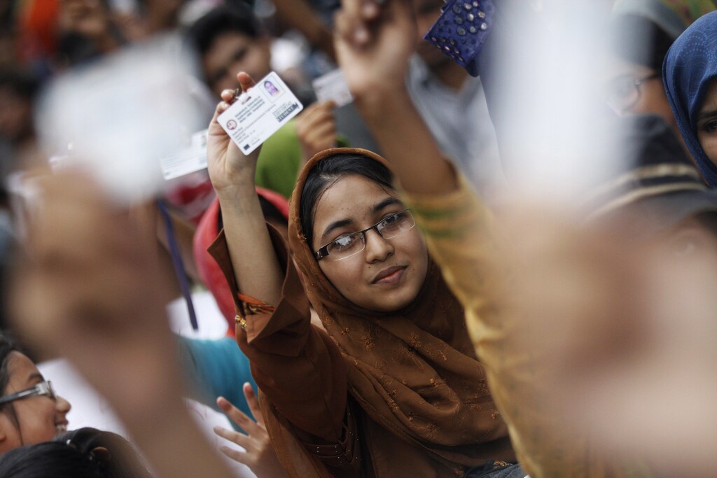 Students at Bangladesh University of Engineering and Technology (BUET) show their identity cards as they take part in a protest following a silent procession to demand the removal of the university's Vice Chancellor and Pro-Vice Chancellor in Dhaka July 15, 2012. Bangladesh aims to get the full picture on corruption in the education ministry by installing closed-circuit television cameras in its key offices in the capital to catch bureaucrats taking bribes for services. Picture taken on July 15, 2012. REUTERS/Andrew Biraj (BANGLADESH - Tags: EDUCATION CIVIL UNREST) - GM1E87H1RCW01