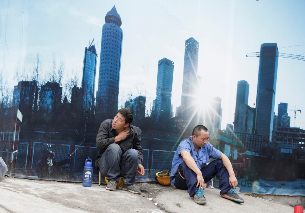 Workers rest outside a construction site in Beijing's central business district, China, July 15, 2016. REUTERS/Jason Lee - RTSI0J9