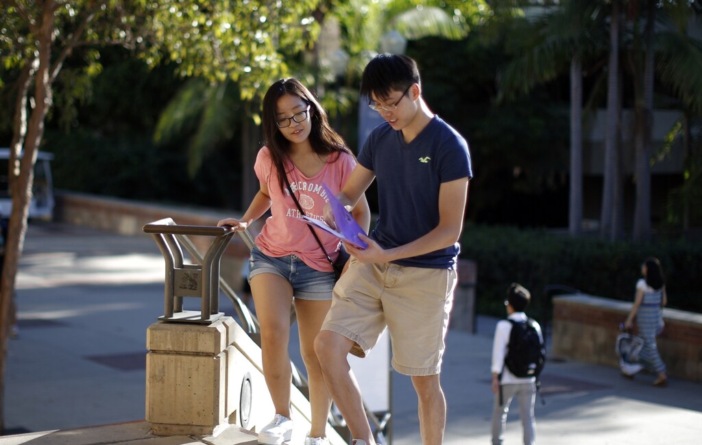 Economics major Hazel Ho, 21, (L) and math major Vincent Yeung, 21, walk on campus as around 12,000 new University of California, Los Angeles (UCLA) students move into campus residence halls in preparation for the new school year beginning October 2, in Los Angeles, California September 25, 2014.