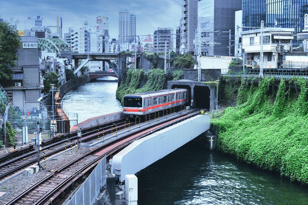 This image shows a train crossing a railway bridge in Japan to illustrate Japan's railways powering into the future