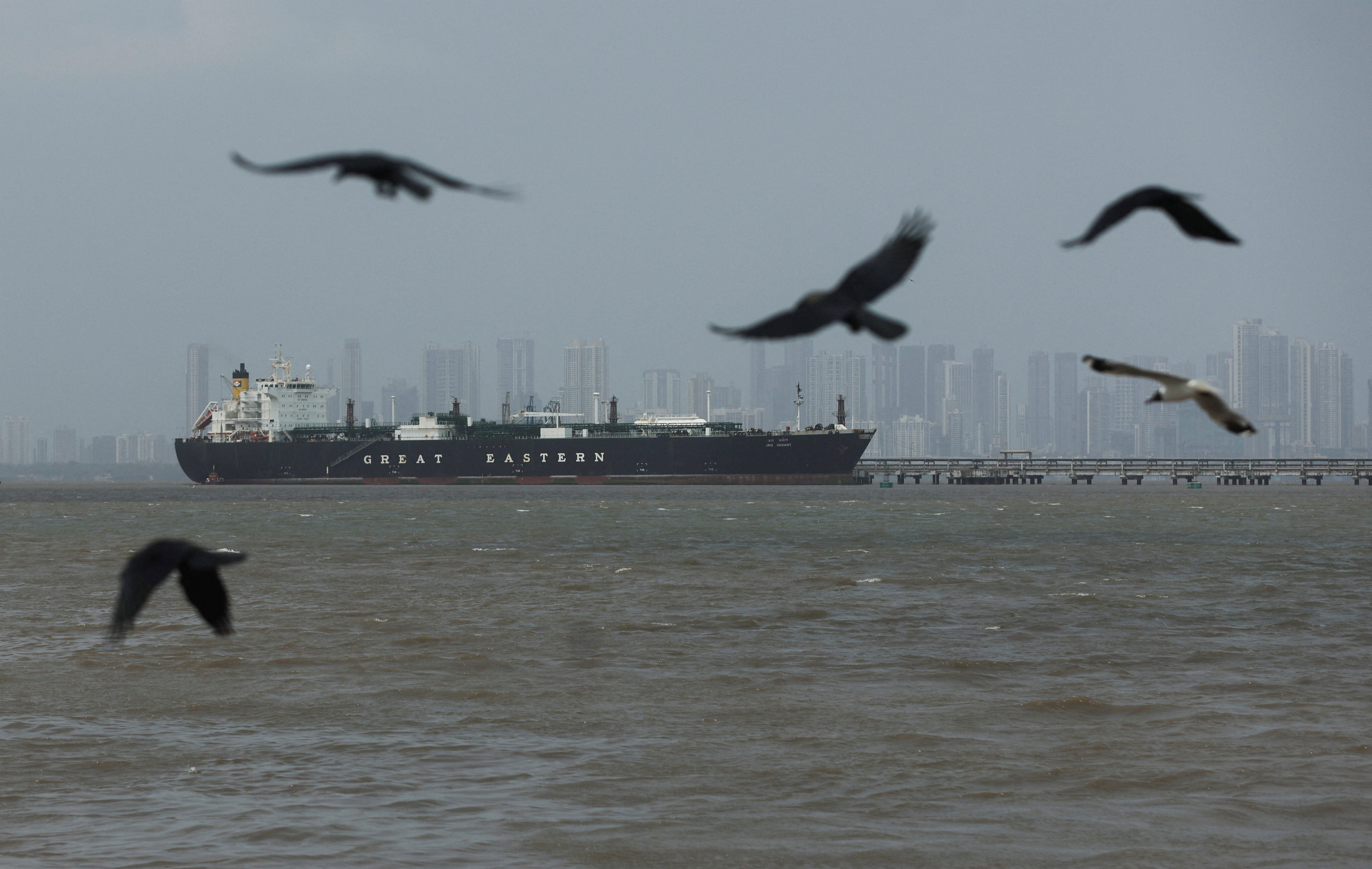 Birds fly near the Jag Vasant vessel transferring LPG at a port after transiting the Strait of Hormuz amid energy supply disruptions linked to the U.S-Israeli conflict with Iran, in Mumbai, India, April 1, 2026. 