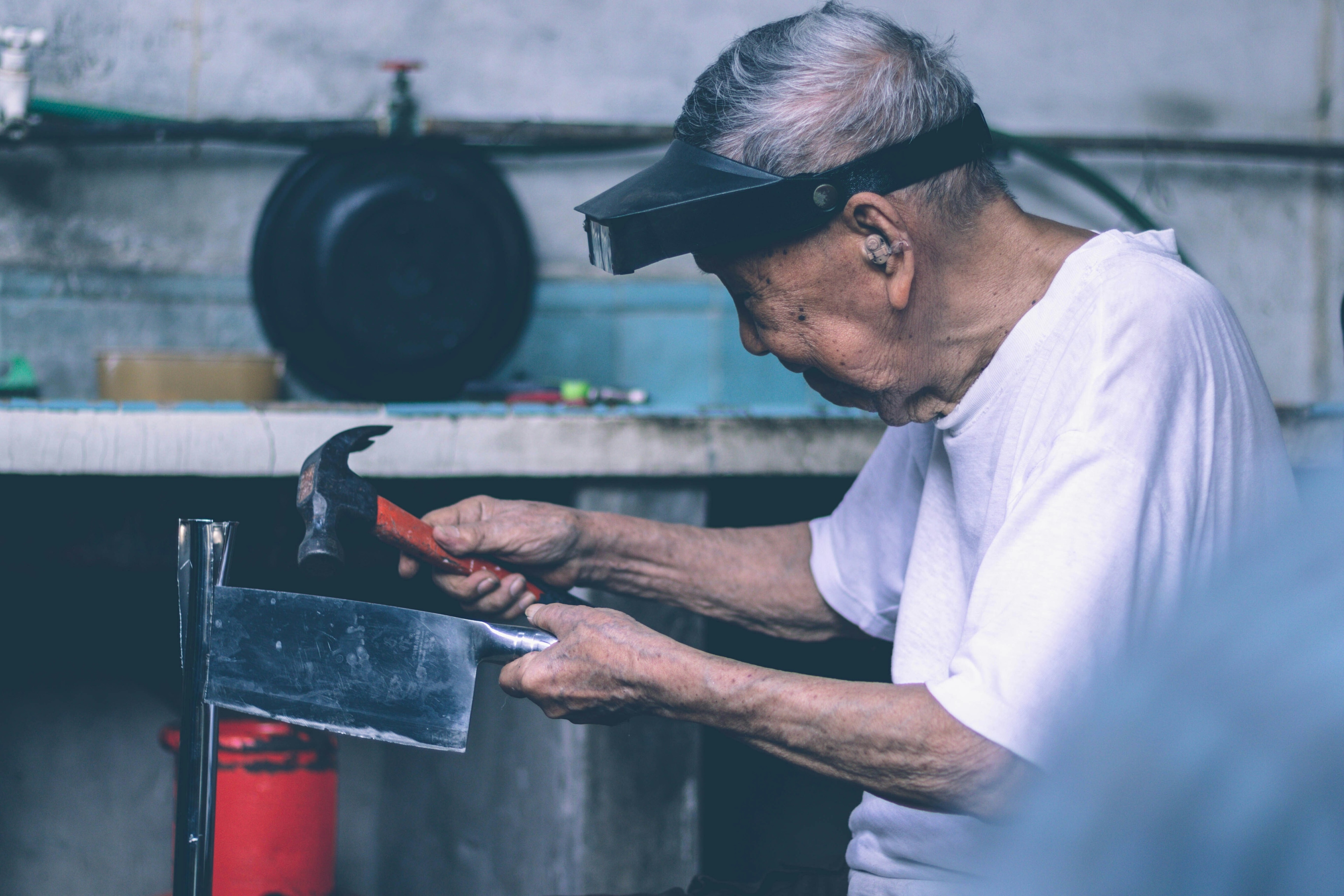 An older man working with tools, part of the longevity economy