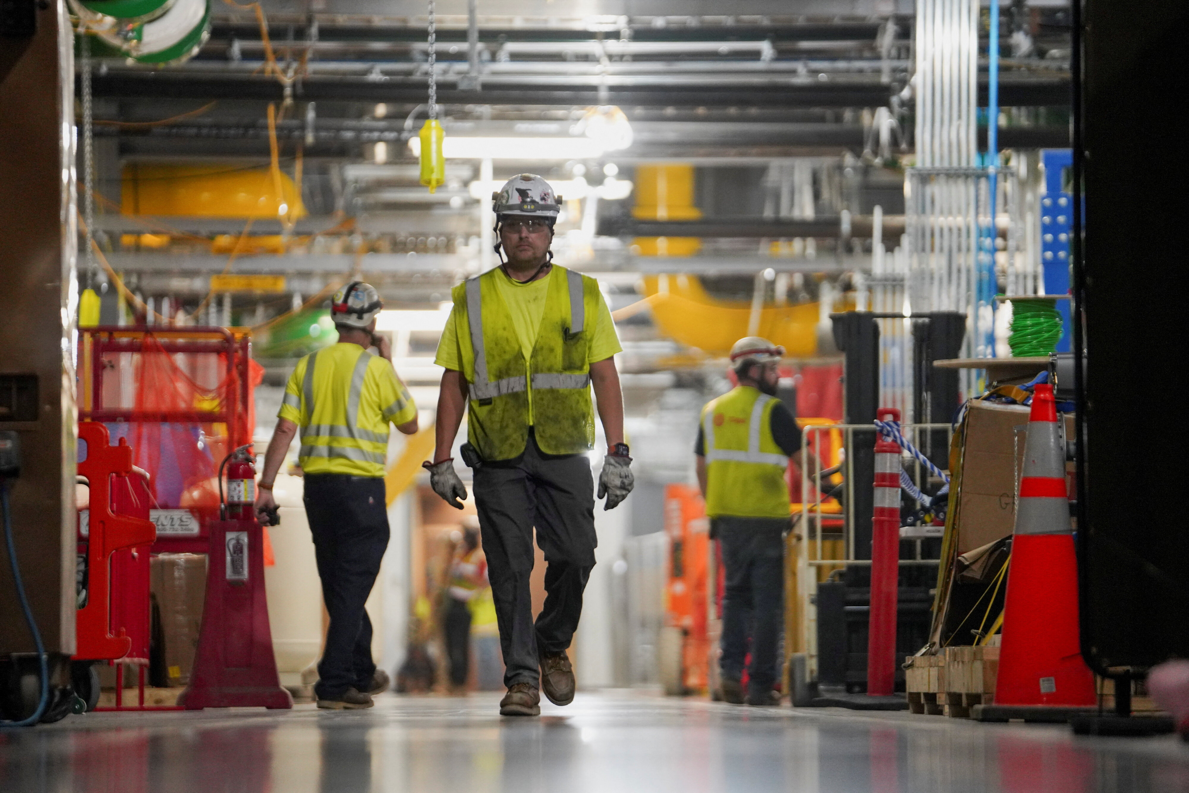 People work inside the Microsoft data center campus' Graphical Processing Unit, currently under construction, after Microsoft's Vice Chair and President Brad Smith announced a plan to spend $4 billion on an additional artificial intelligence data center, in Mount Pleasant, Wisconsin, U.S., September 18, 2025.  REUTERS/Audrey Richardson