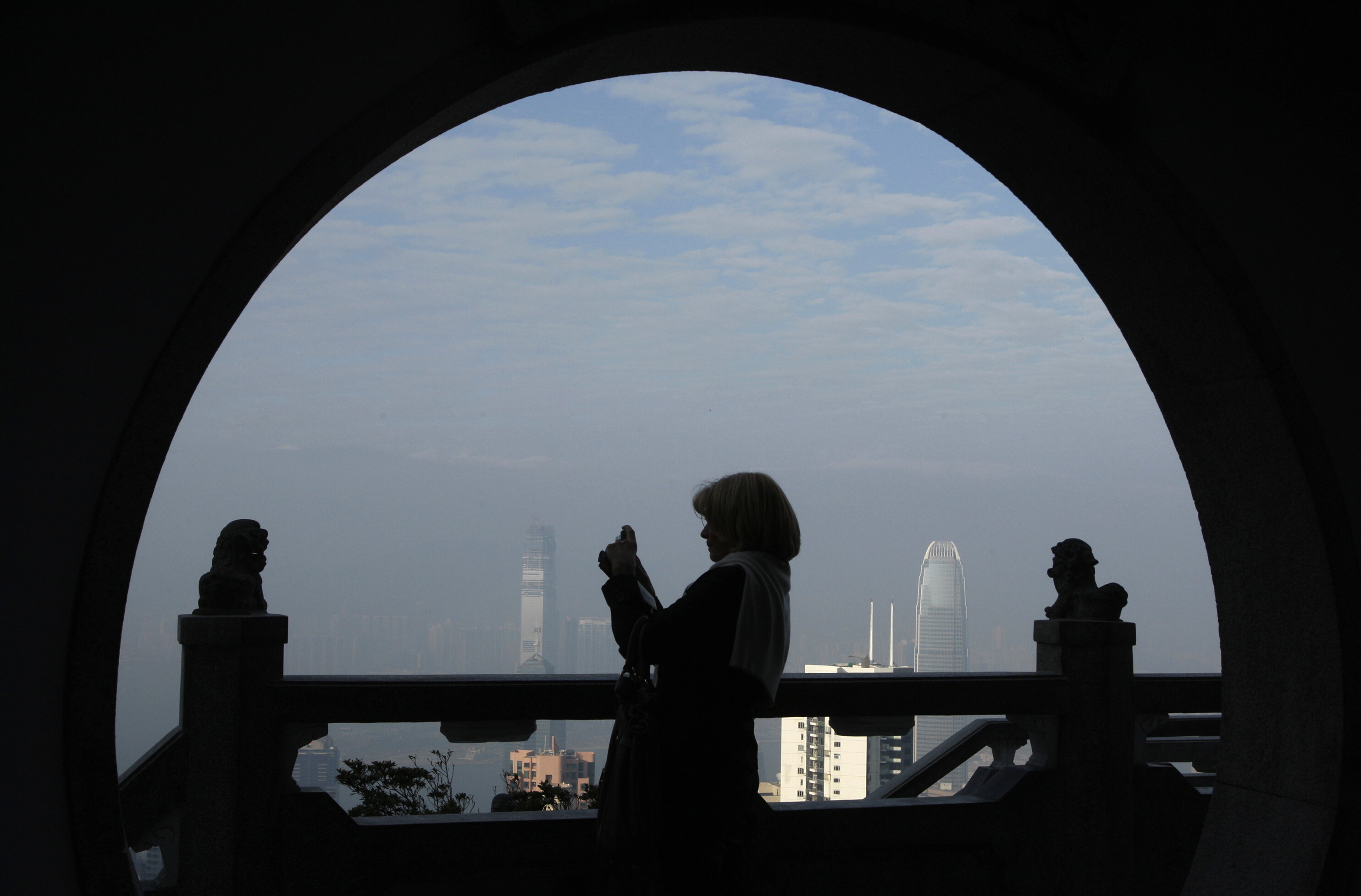 A foreign visitor takes a picture at the Peak, the most popular sightseeing spot for tourists, in Hong Kong January 20, 2009: Travel and tourism contribute over 10% of global gross domestic product