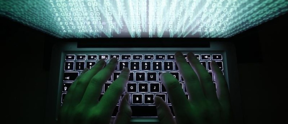 A man types on a computer keyboard in Warsaw in this February 28, 2013 illustration file picture. One of the largest ever cyber attacks is slowing global internet services after an organisation blocking "spam" content became a target, with some experts saying the disruption could get worse. 