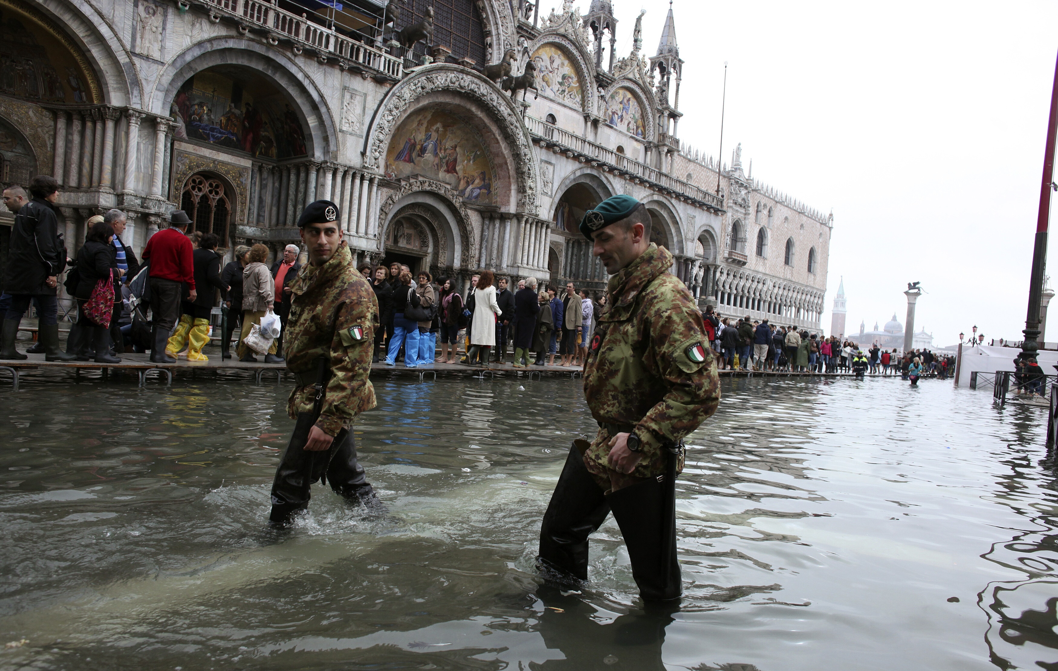 Italian army soldiers patrol in St. Mark Square during a period of seasonal high water in Venice October 27, 2012. The water level in the canal city rose to 127 cm (50 inches) above the normal level, according to the monitoring institute: European defence capabilities should include climate-responsive dual-use technologies.