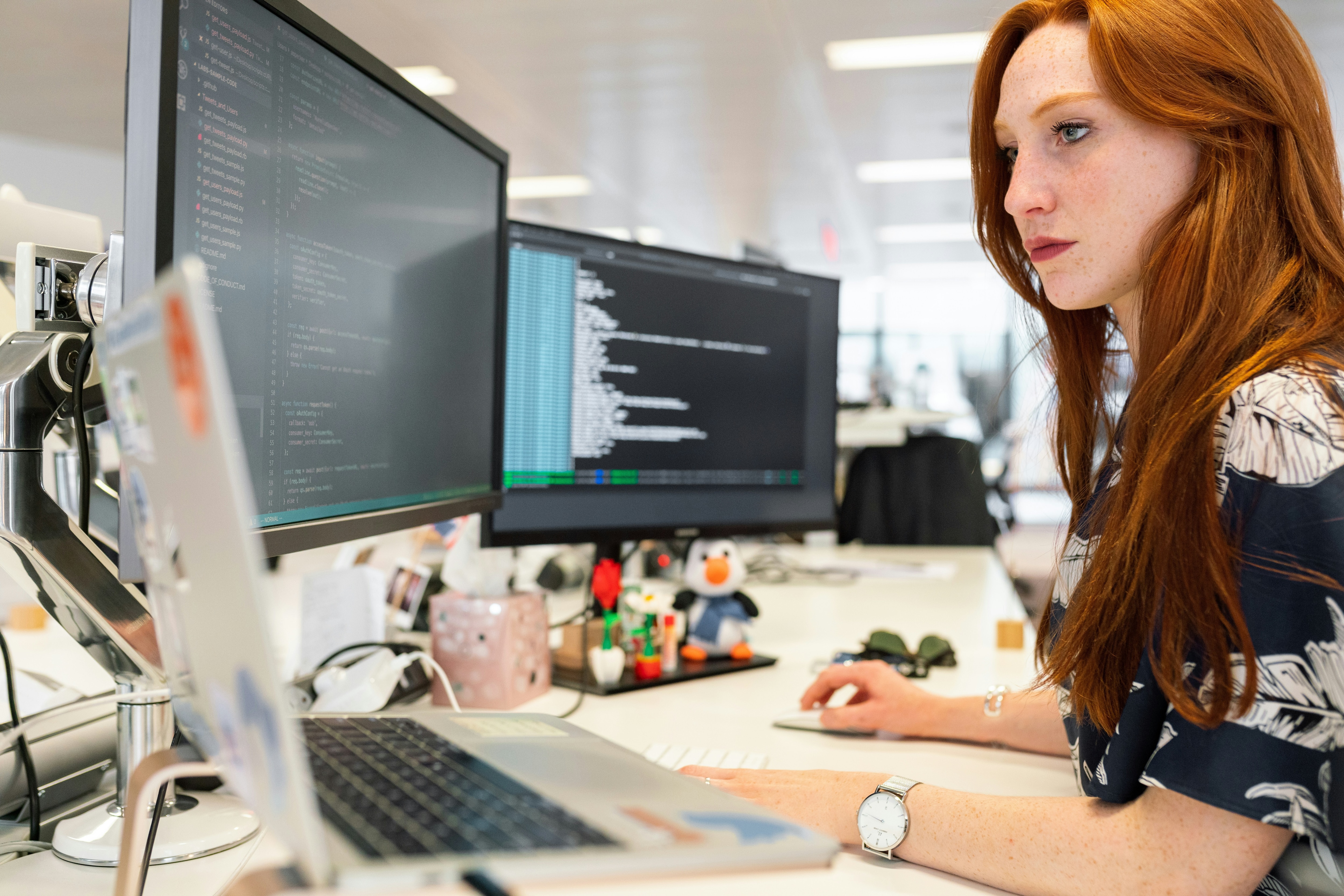 A woman looks at a computer screen.