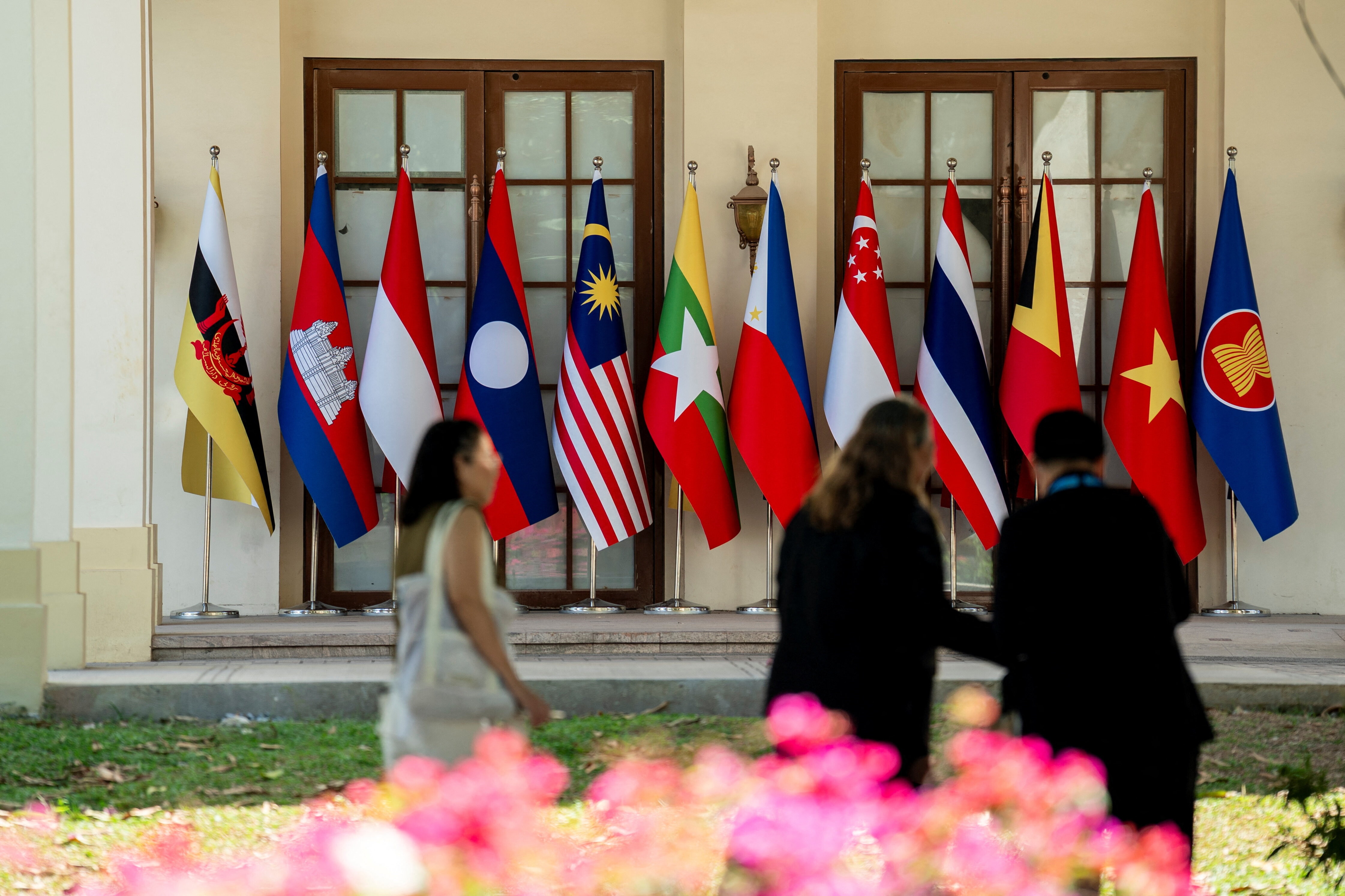 People walk towards the flags of Association of Southeast Asian Nations (ASEAN) member states during the 48th ASEAN Summit and Related MeetingsÂ in Cebu, Philippines, May 8, 2026. REUTERS/Lisa Marie David