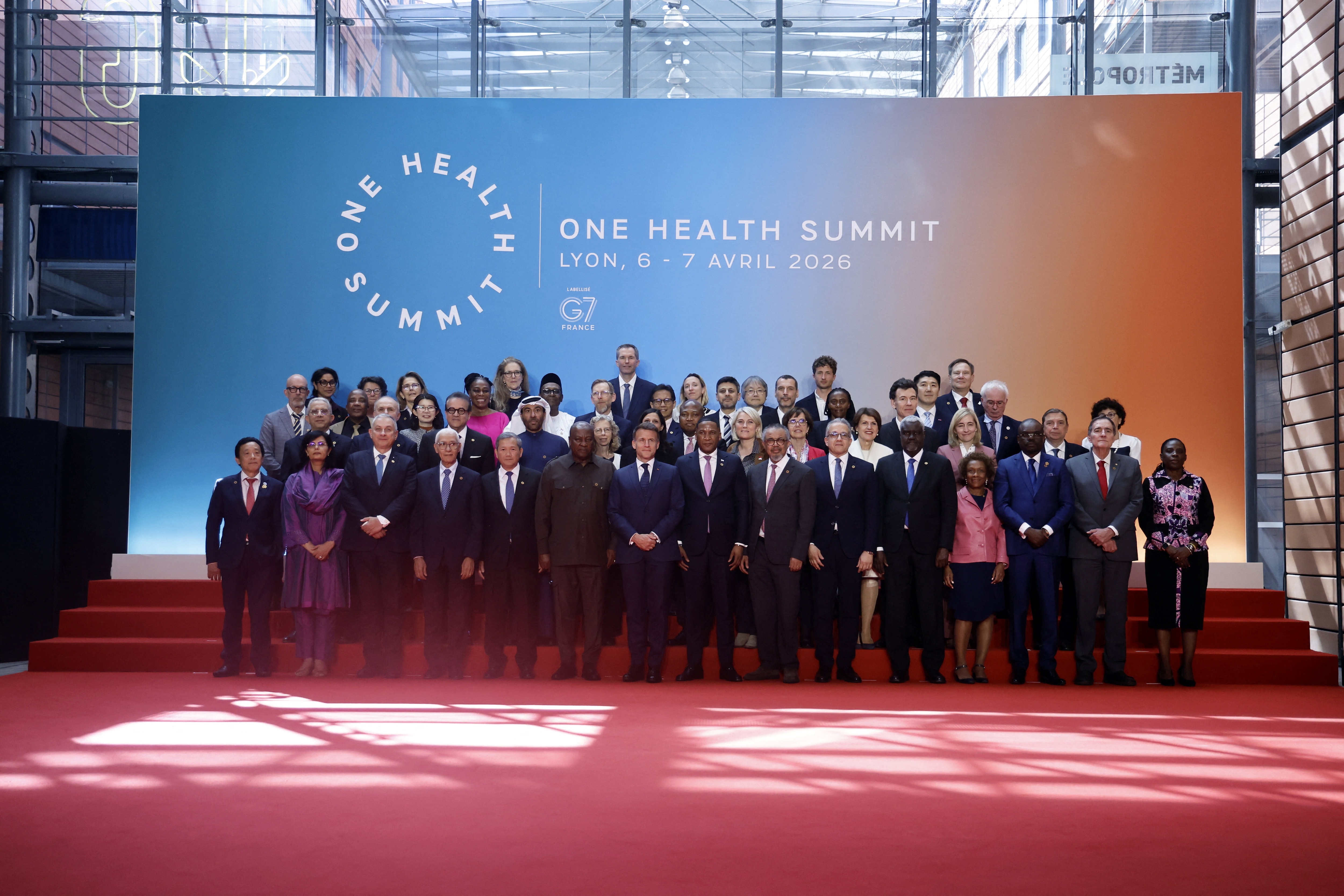 French President Emmanuel Macron with delegates pose for a family photo during the 'One Health Summit' in Lyon, France.