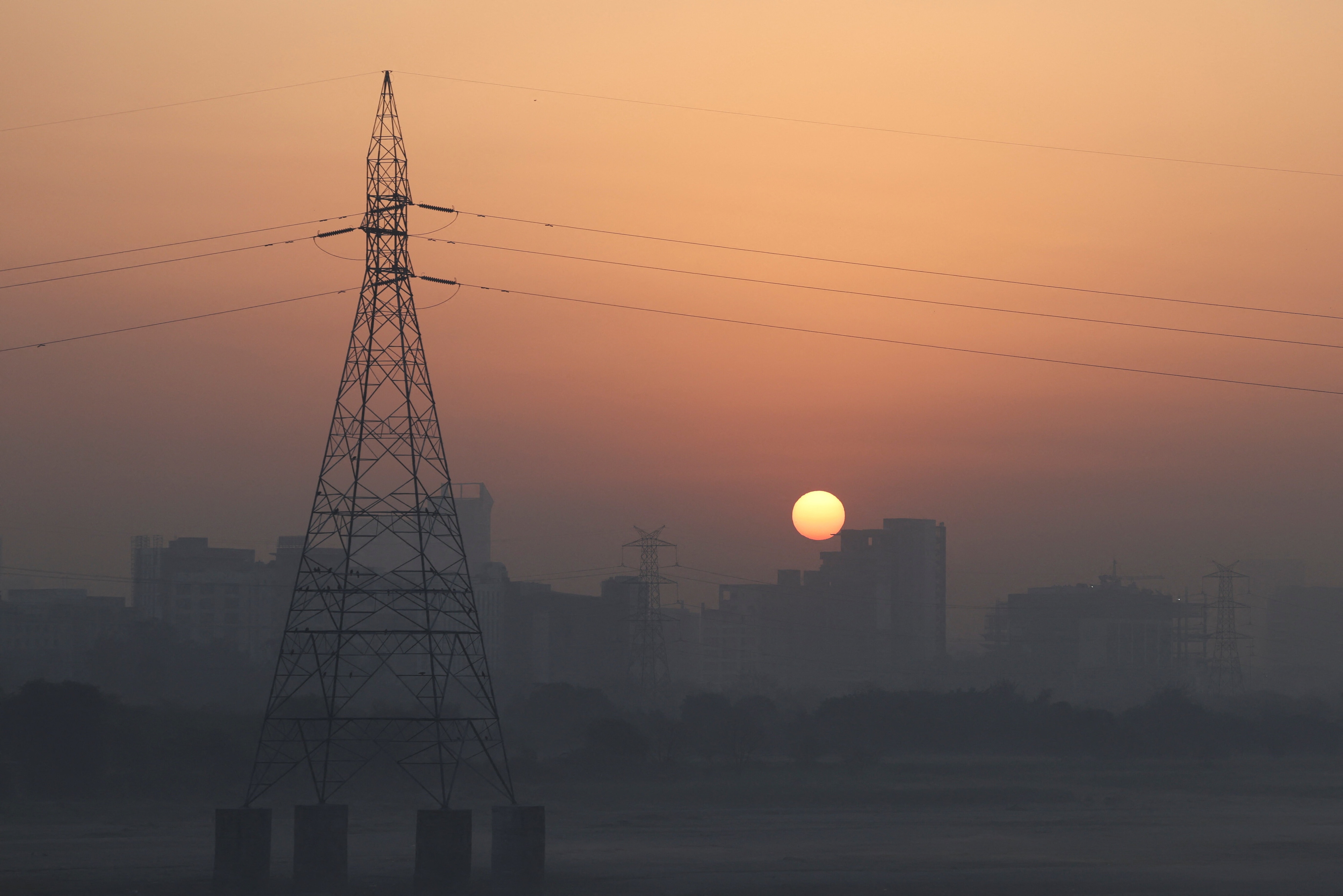 The sun rises behind buildings on a hazy morning in New Delhi, India, February 27, 2026. maintenance gap