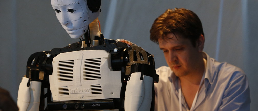 A technician makes adjustments to the "Inmoov" robot from Russia during the "Robot Ball" scientific exhibition in Moscow May 17, 2014. Picture taken May 17, 2014.