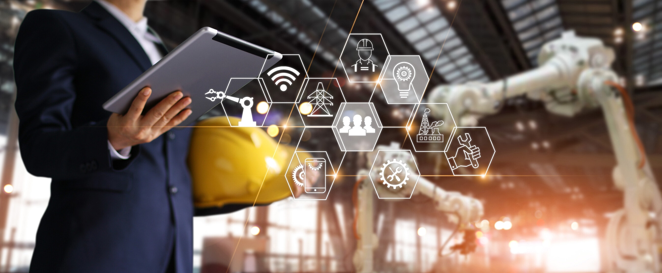 A futuristic architect, Businessman, Engineer manager using tablet with icon network, AI agents Industrial robotics, Automation robot arms machine in intelligent construction site. Construction technology concept
