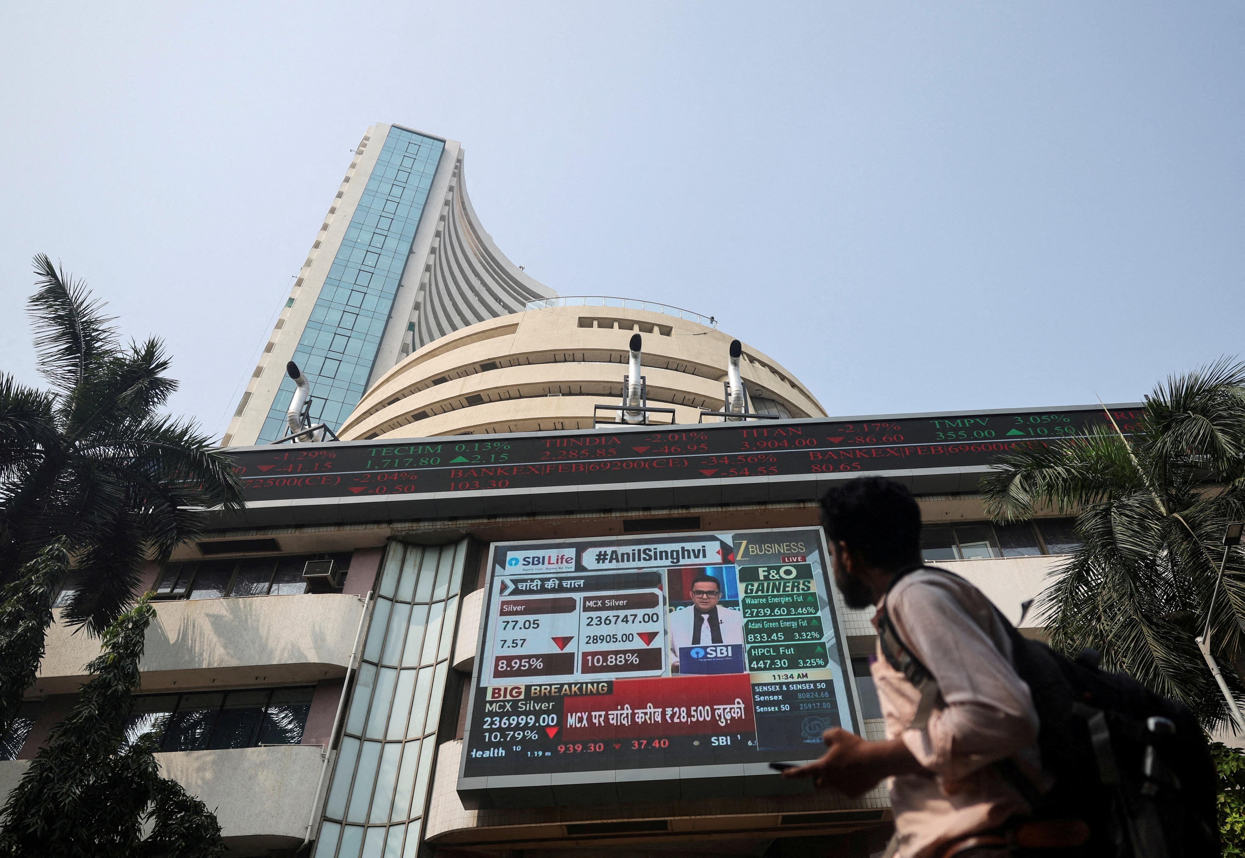 A man looks at a screen outside the Bombay Stock Exchange (BSE) building in Mumbai, India, February 2, 2026.