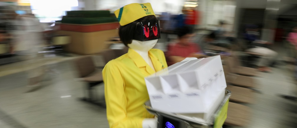 A robot wearing a nurse costume carries medical documents at Mongkutwattana General Hospital in Bangkok, Thailand, February 6, 2019. REUTERS/Athit Perawongmetha - RC1426C39760