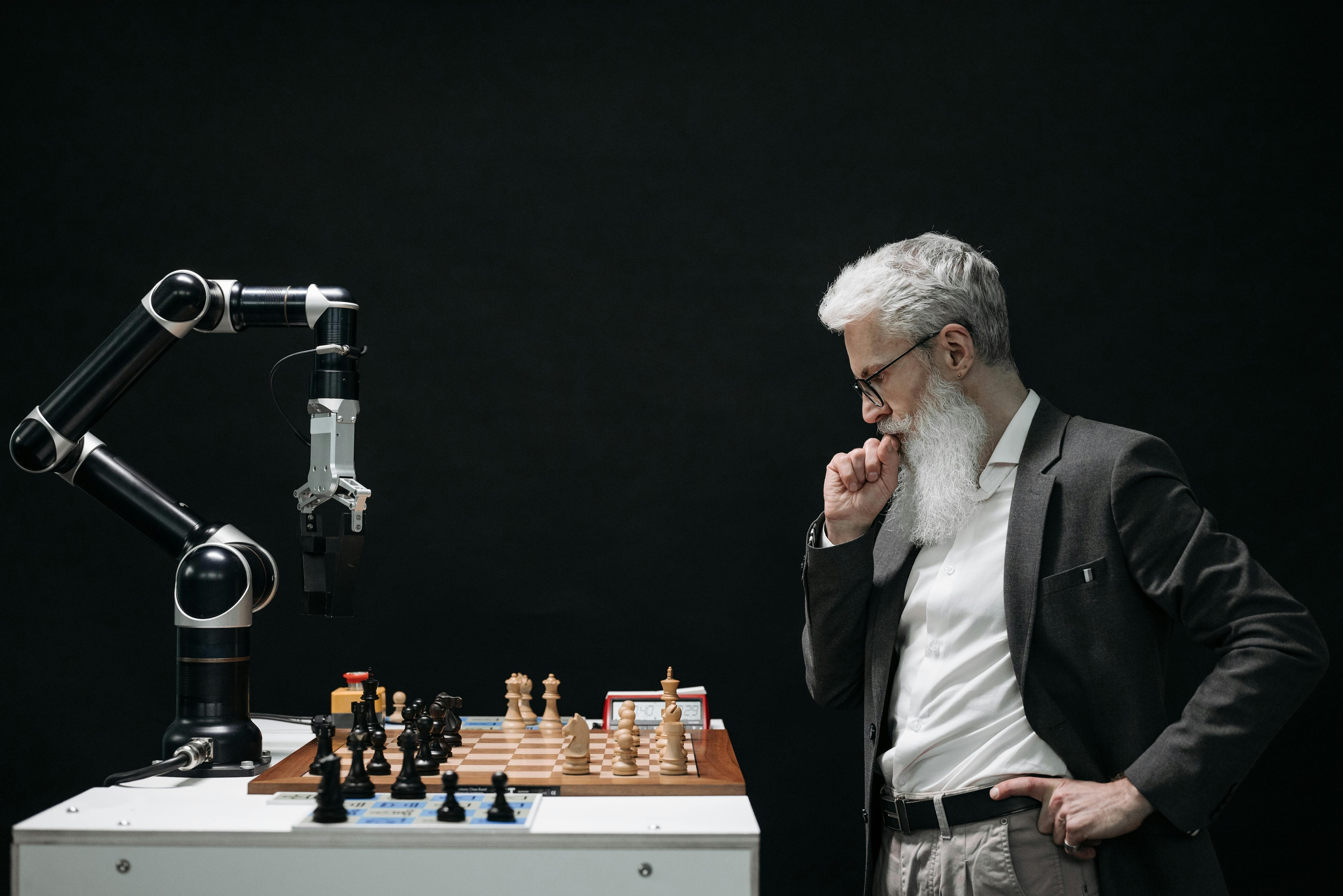 A man playing chess against a computer; neurodivergent minds could help develop AI for the better.