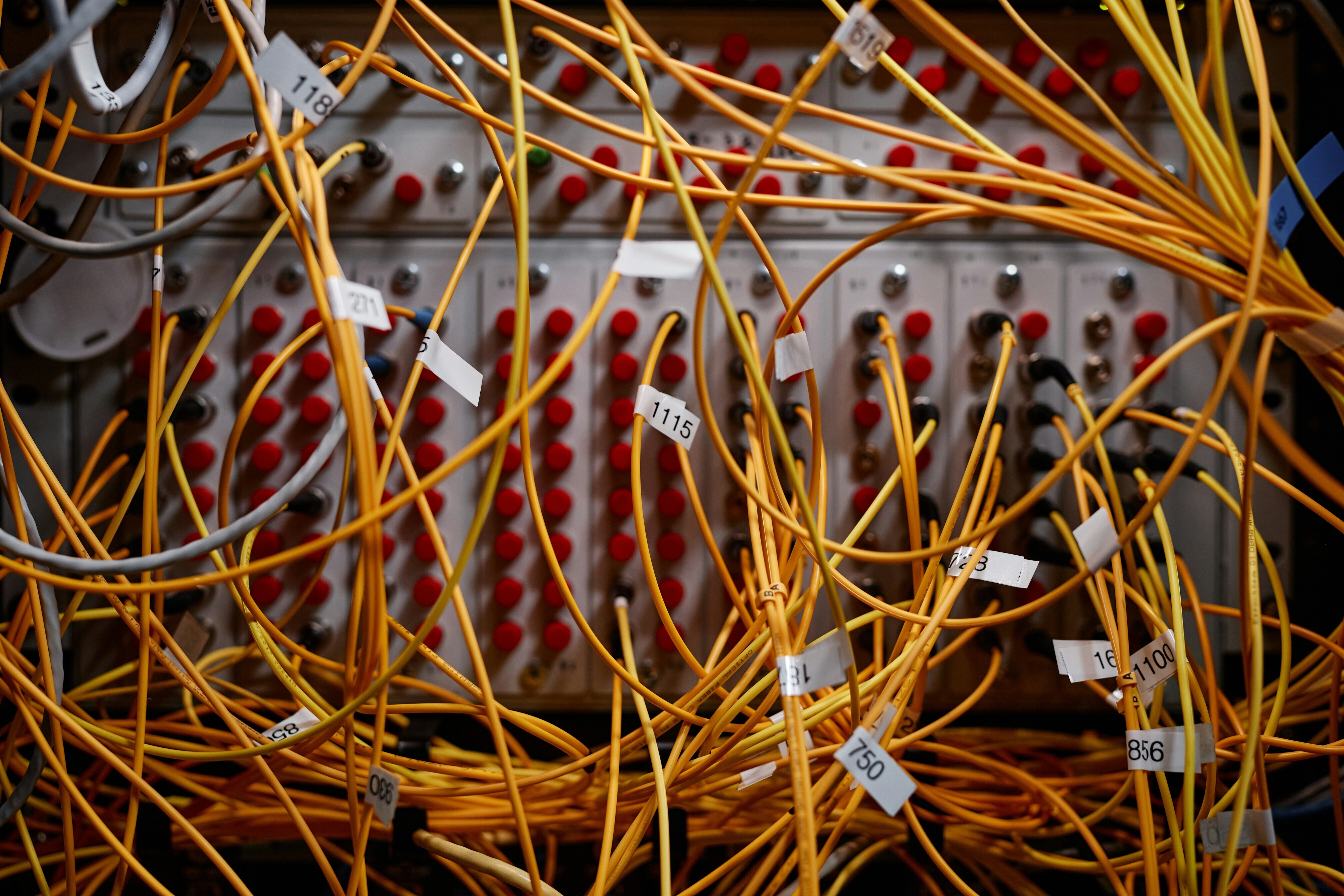 Close up background image of server cabinet with yellow internet cables and wires connected to ports. data architecture