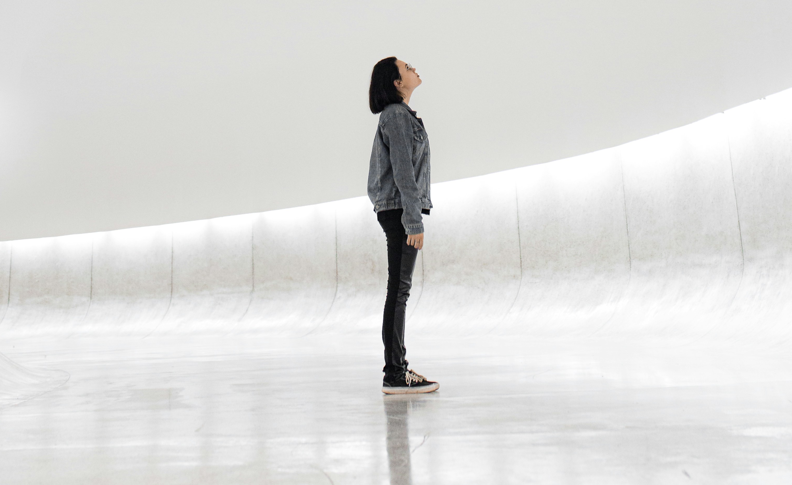 Woman looking at white wall: Every generation has a fear of the future