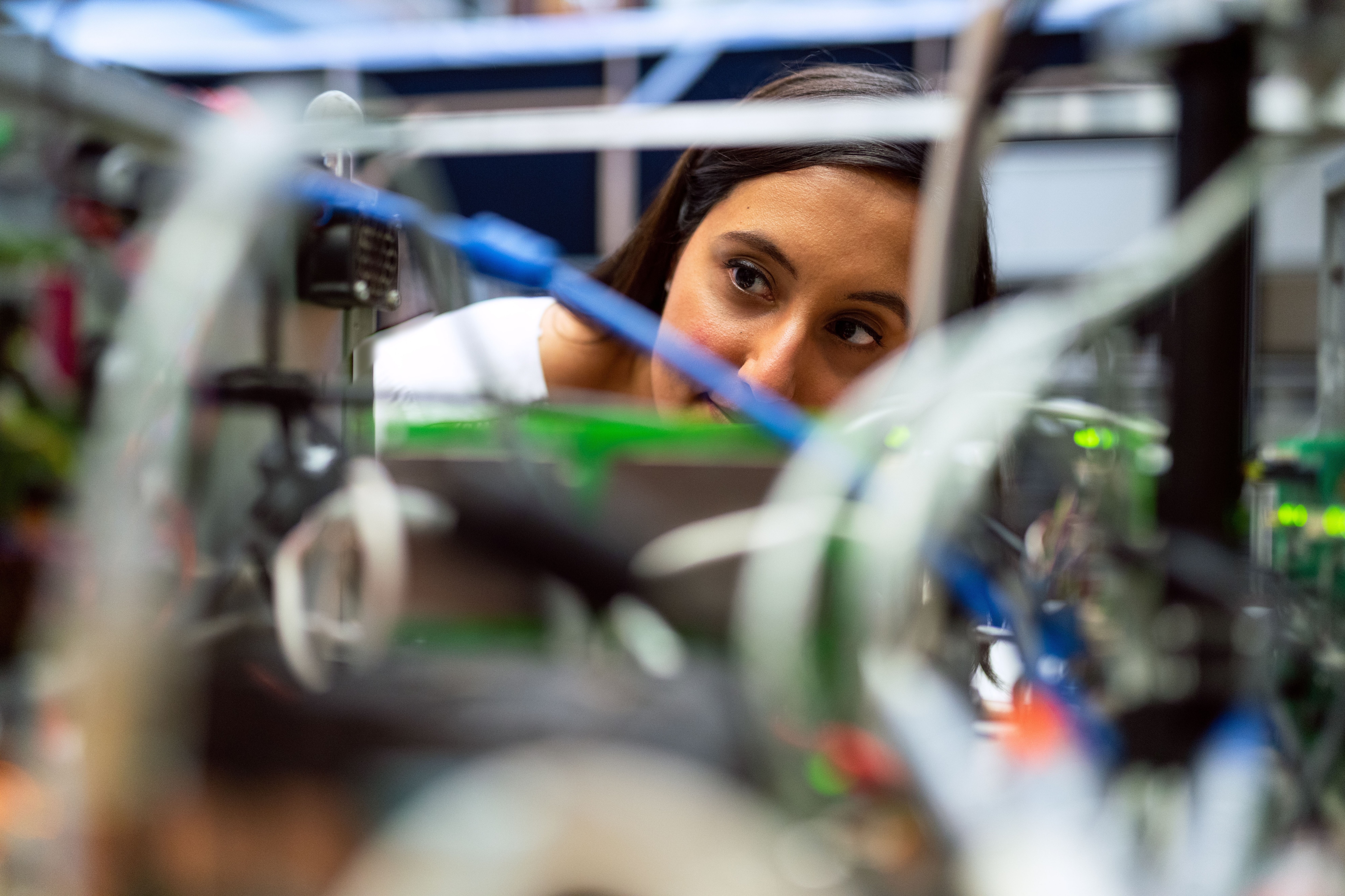 A woman looks at equipment in a lab; Focused engineer analyzing equipment at a modern lab; innovation prize