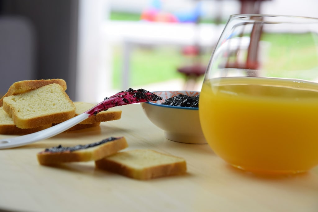 Toast with jam and a jug of juice on a table: Sugar has been stripped of a vital ingredient for our health – fibre