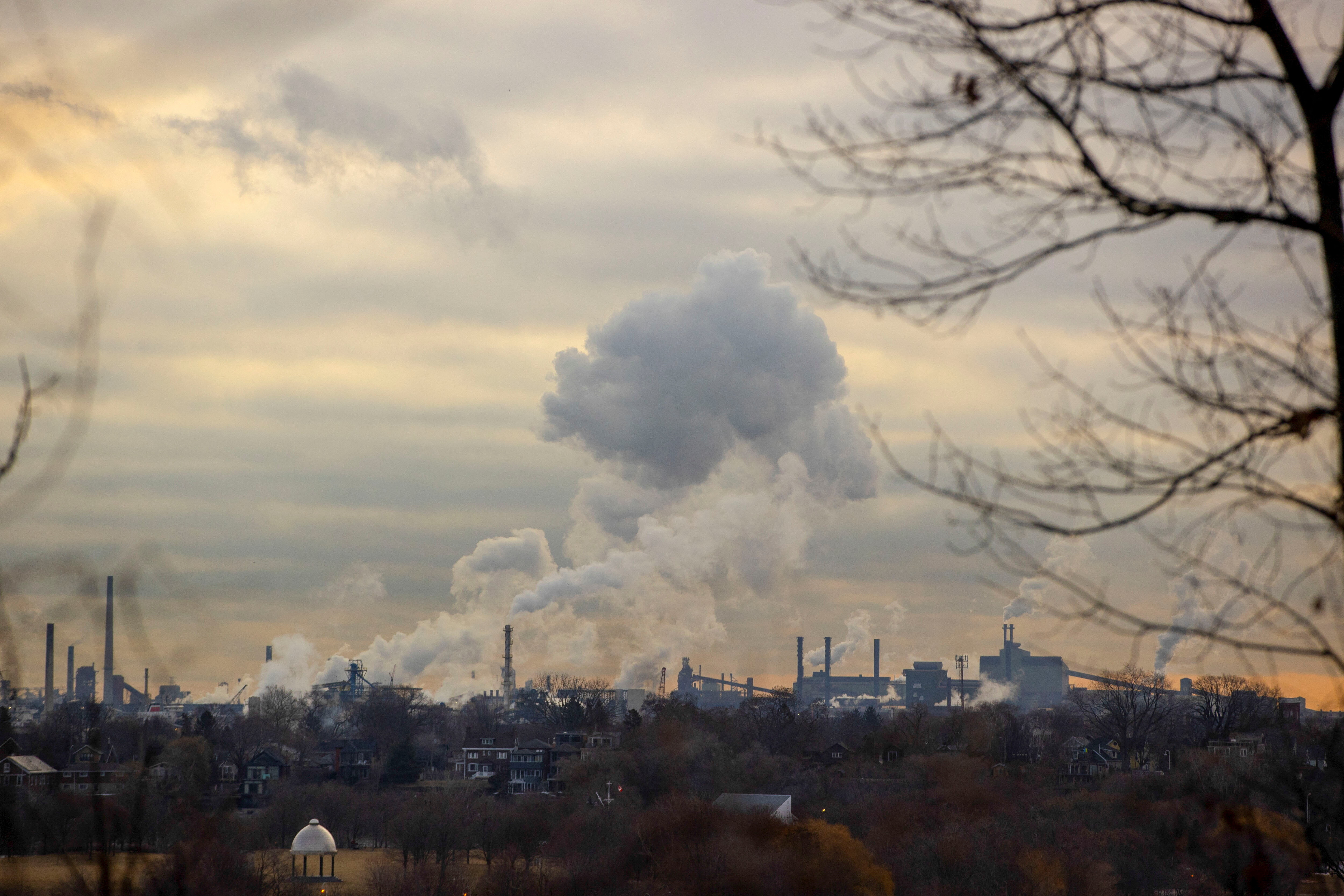 Emissions billows from an industrial sector housing steel companies in Hamilton, Ontario, Canada, March 13, 2025.