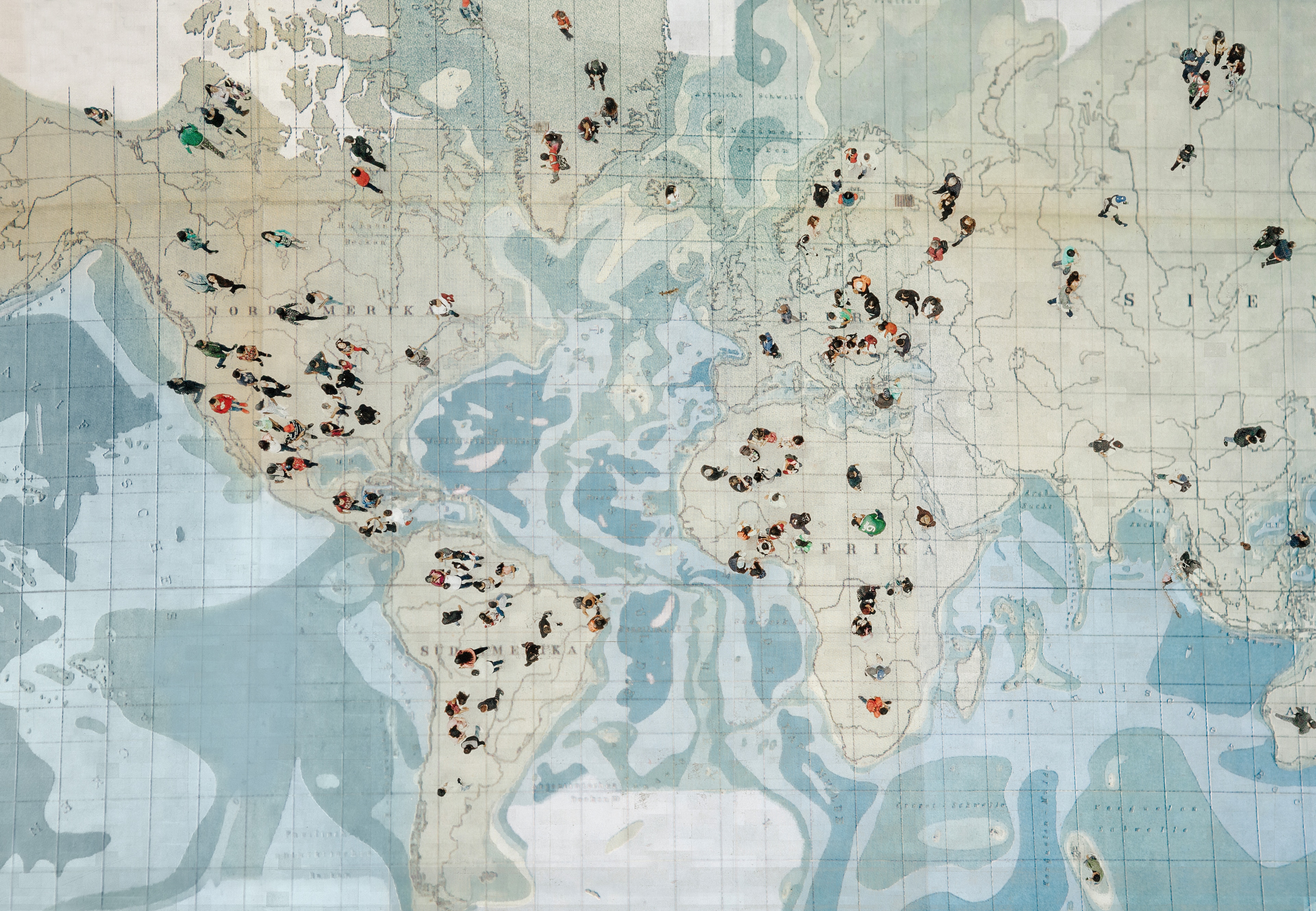 Crowd walking on global map. Composition made with antique map. The global relationship between entrepreneurship and sustainability is deepening.