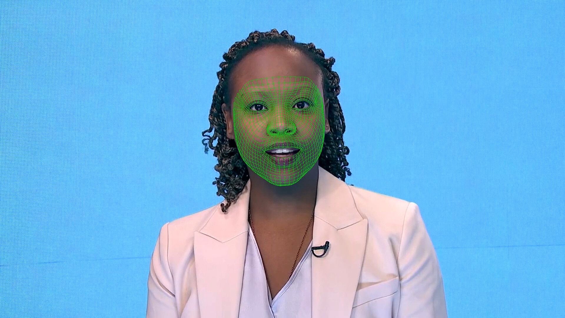 A green wireframe model covers an actor's lower face during the creation of a synthetic facial reanimation video, known alternatively as a deepfake, in London, Britain.