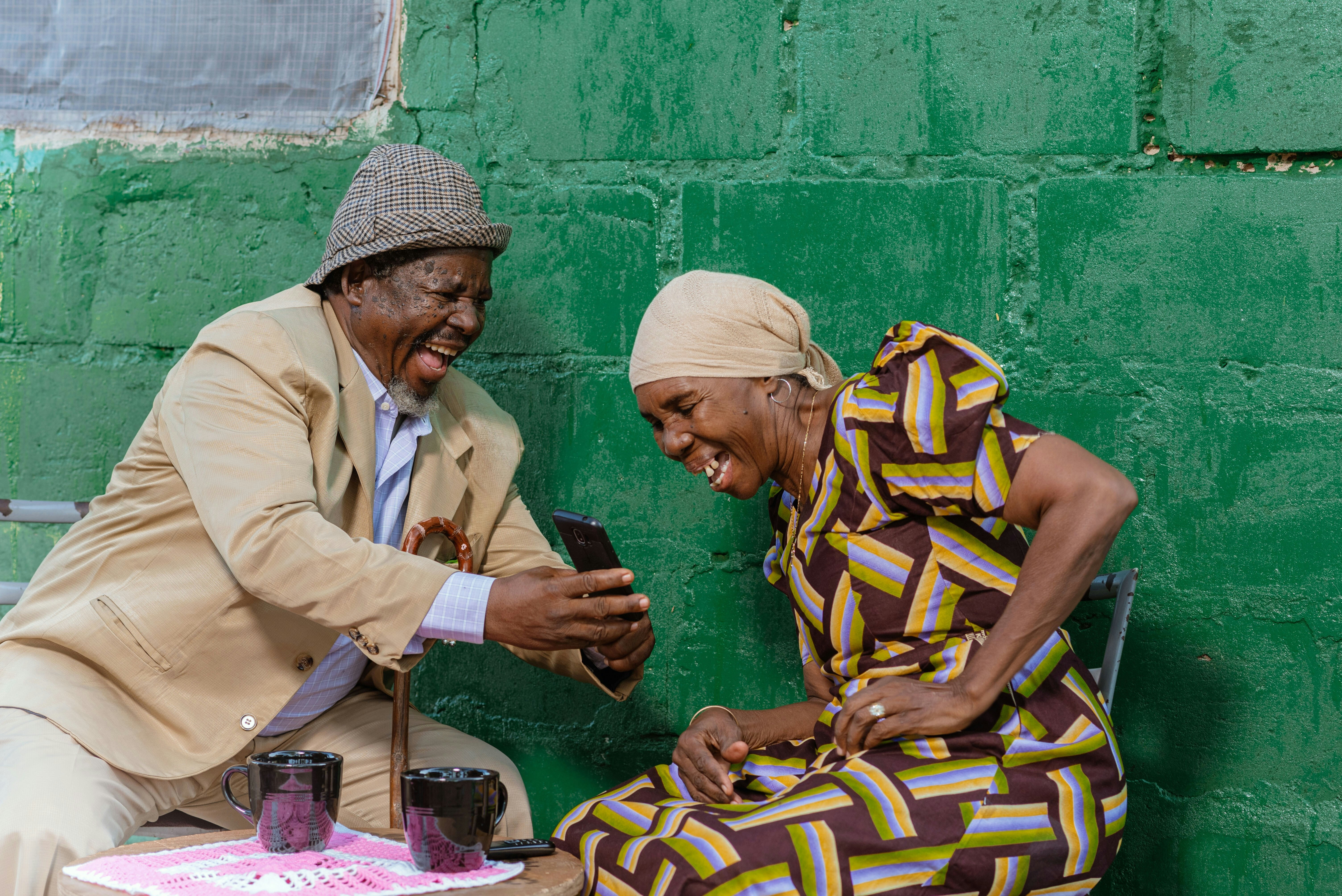 Two elderly people laughing, illustrating longevity.