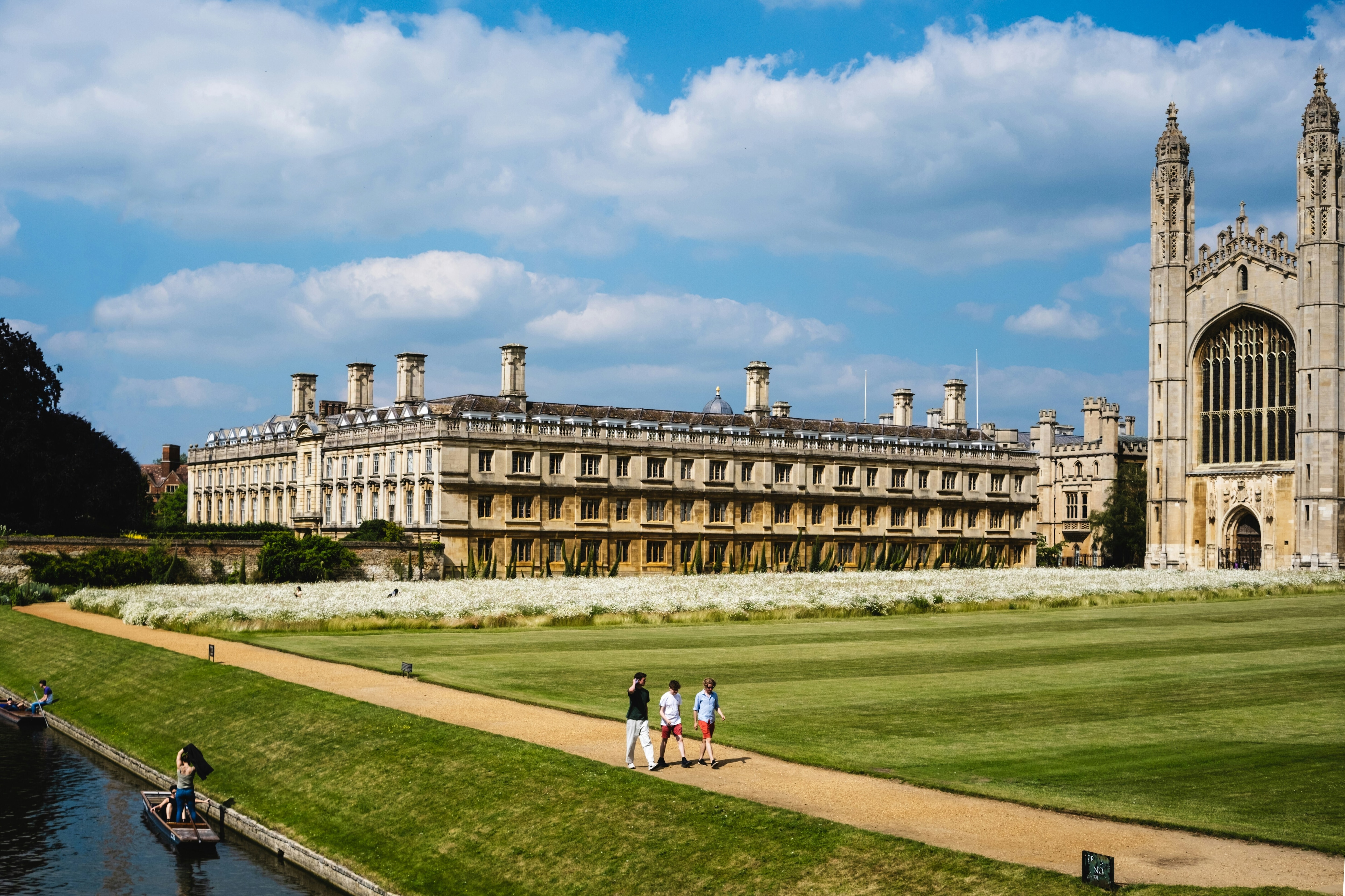 A wide shot of Cambridge University with people walking in front of it: The academia-business collaboration is underperforming