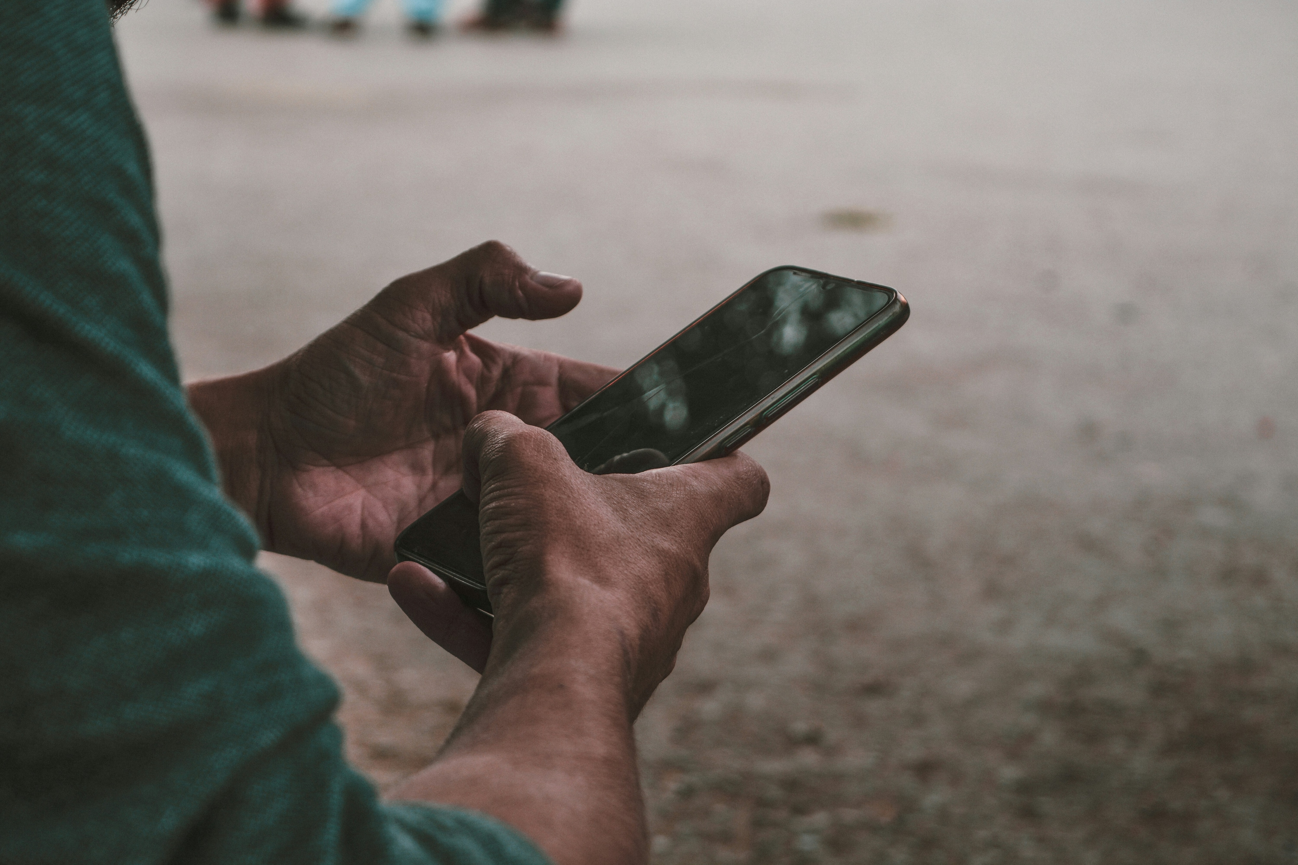 Boy is using mobile, A young boy engrossed in his mobile phone; digital identity