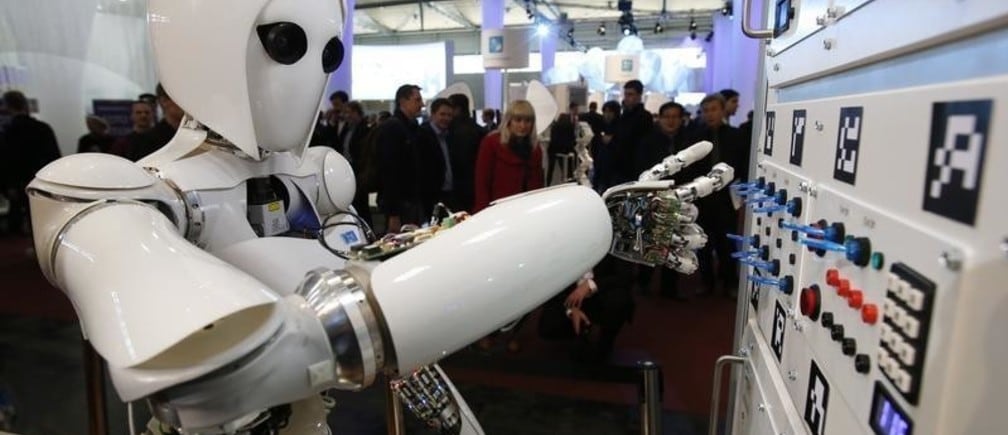 The humanoid robot AILA (artificial intelligence lightweight android) operates a switchboard during a demonstration by the German research centre for artificial intelligence at the CeBit computer fair in Hanover March, 5, 2013. The biggest fair of its kind open its doors to the public on March 5 and will run till March 9, 2013.  REUTERS/Fabrizio Bensch (GERMANY - Tags: BUSINESS SCIENCE TECHNOLOGY) - BM2E93519ZB01