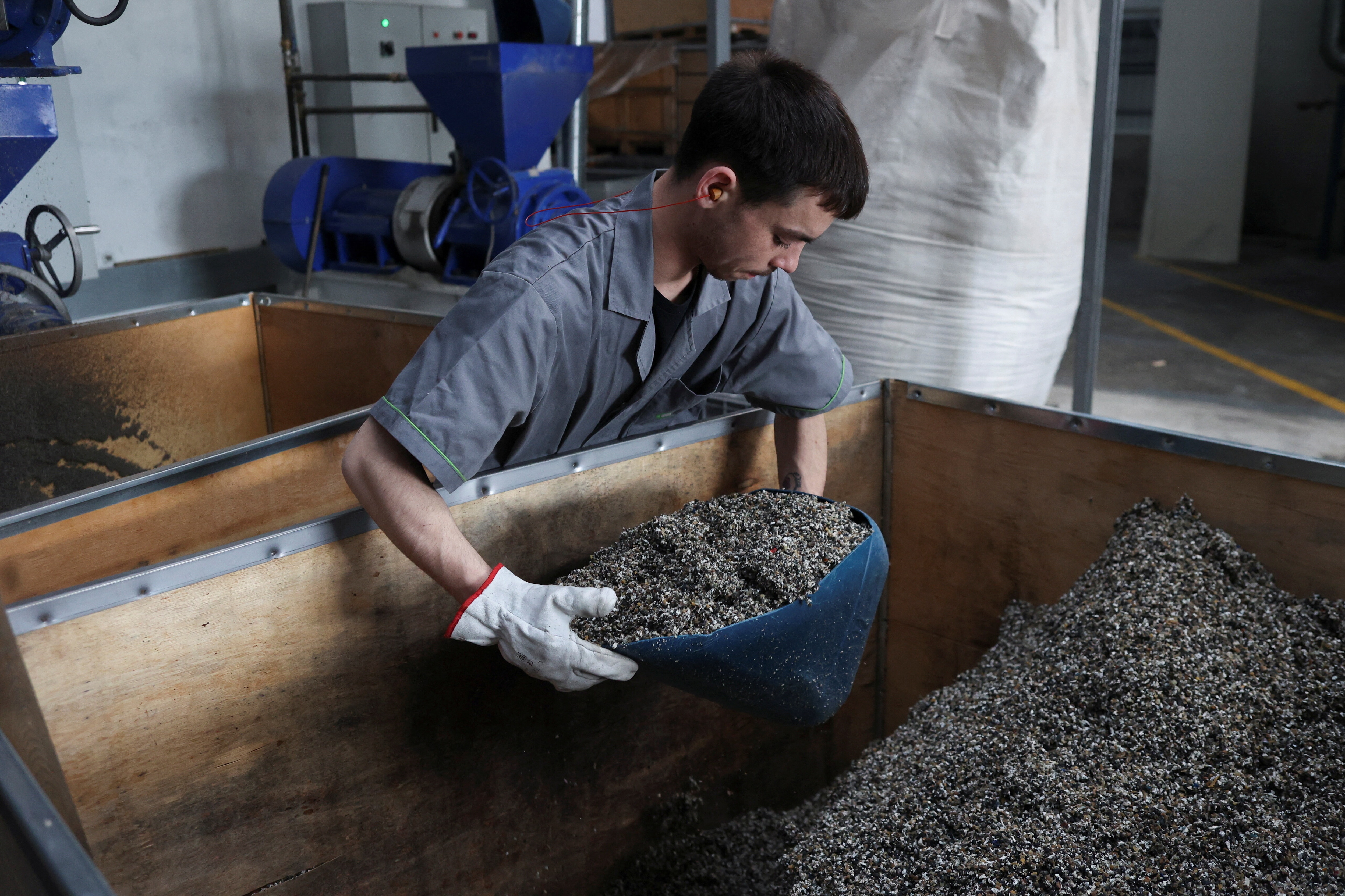 A man holds a tray with recycled material in a factory in Guimaraes, Portugal, February 24, 2023. REUTERS/Pedro Nunes