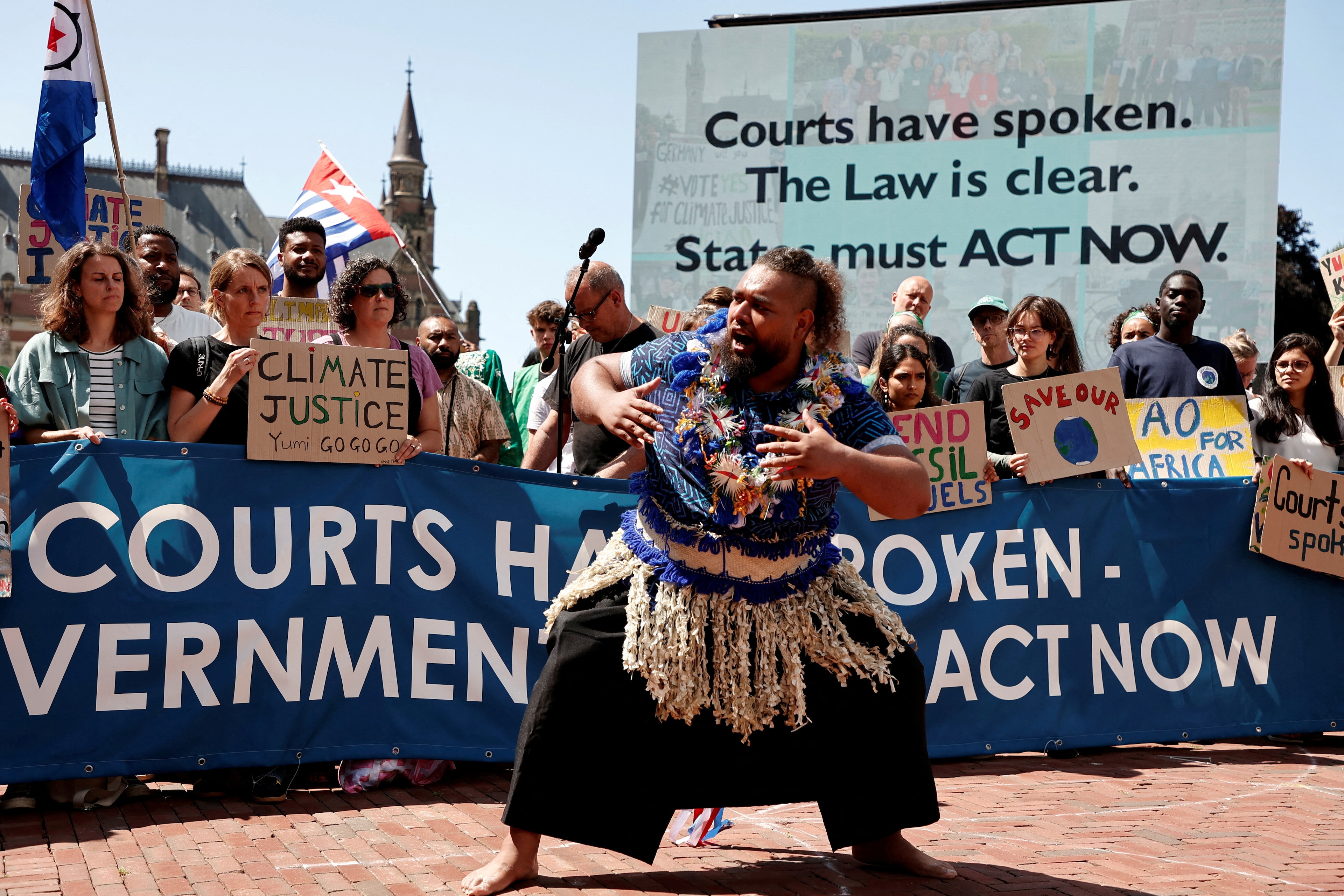 Climate activists and campaigners demonstrate outside the International Court of Justice ahead of the reading of an advisory opinion that is likely to determine the course of future climate action across the world, The Hague, Netherlands.