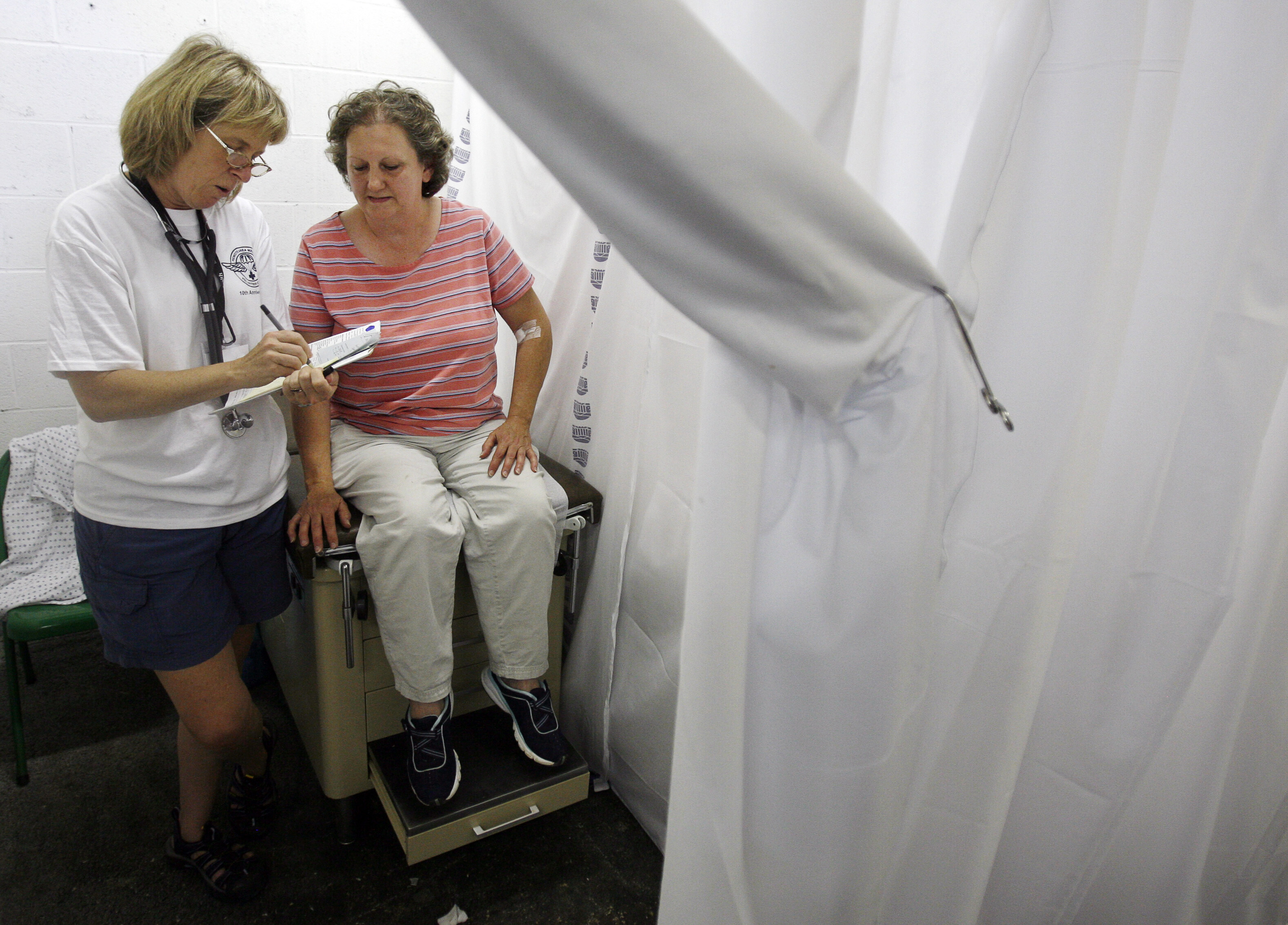 Betty Caudill, 49, speaks with Dr. Molly O'Dell during a medical visit at the Remote Area Medical (RAM) health clinic during the second day at the Wise County Fairgrounds in Wise, Virginia July 25, 2009. The free clinic, which lasts 2 1/2 days, is the largest of its kind in the nation providing medical, dental and vision services from more than 1,400 medical volunteers: Women’s health has been systematically underserved