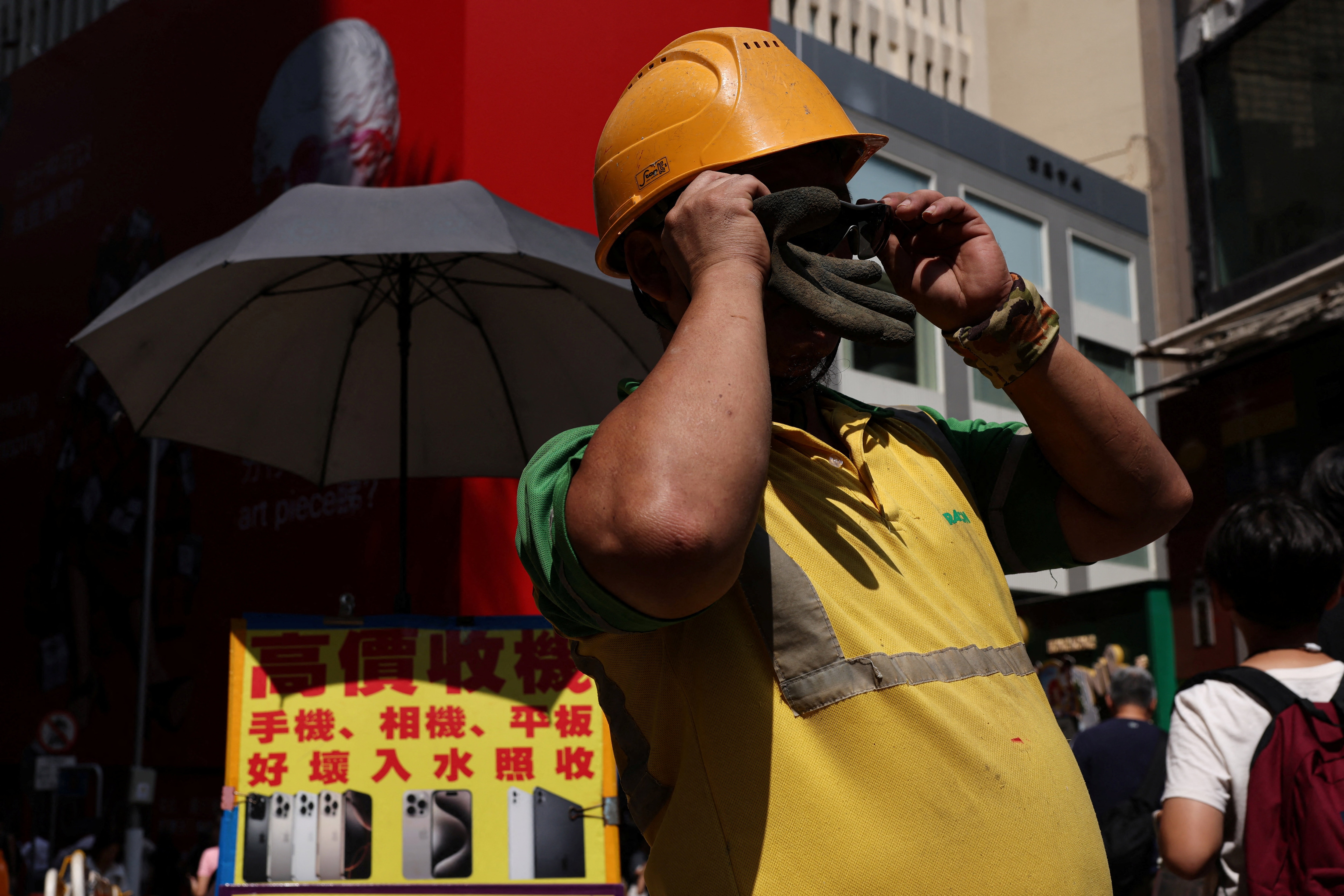 A construction worker wears sunglasses amid a heatwave, in Hong Kong, China, 10 August, 2026.