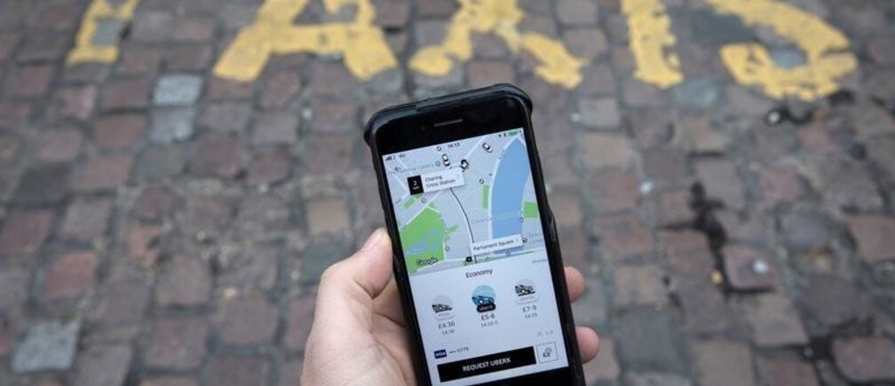A photo illustration shows the Uber app on a mobile telephone, as it is held up for a posed photograph, in London, Britain November 10, 2017. REUTERS/Simon Dawson - RC1976331390