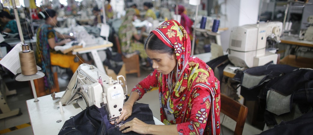 A worker works in a factory of Ananta Garments Ltd in Savar June 10, 2014. Picture taken June 10, 2014. To match Insight BANGLADESH-TEXTILES/ REUTERS/Andrew Biraj (BANGLADESH - Tags: BUSINESS TEXTILE) - GM1EA6O0VOY01