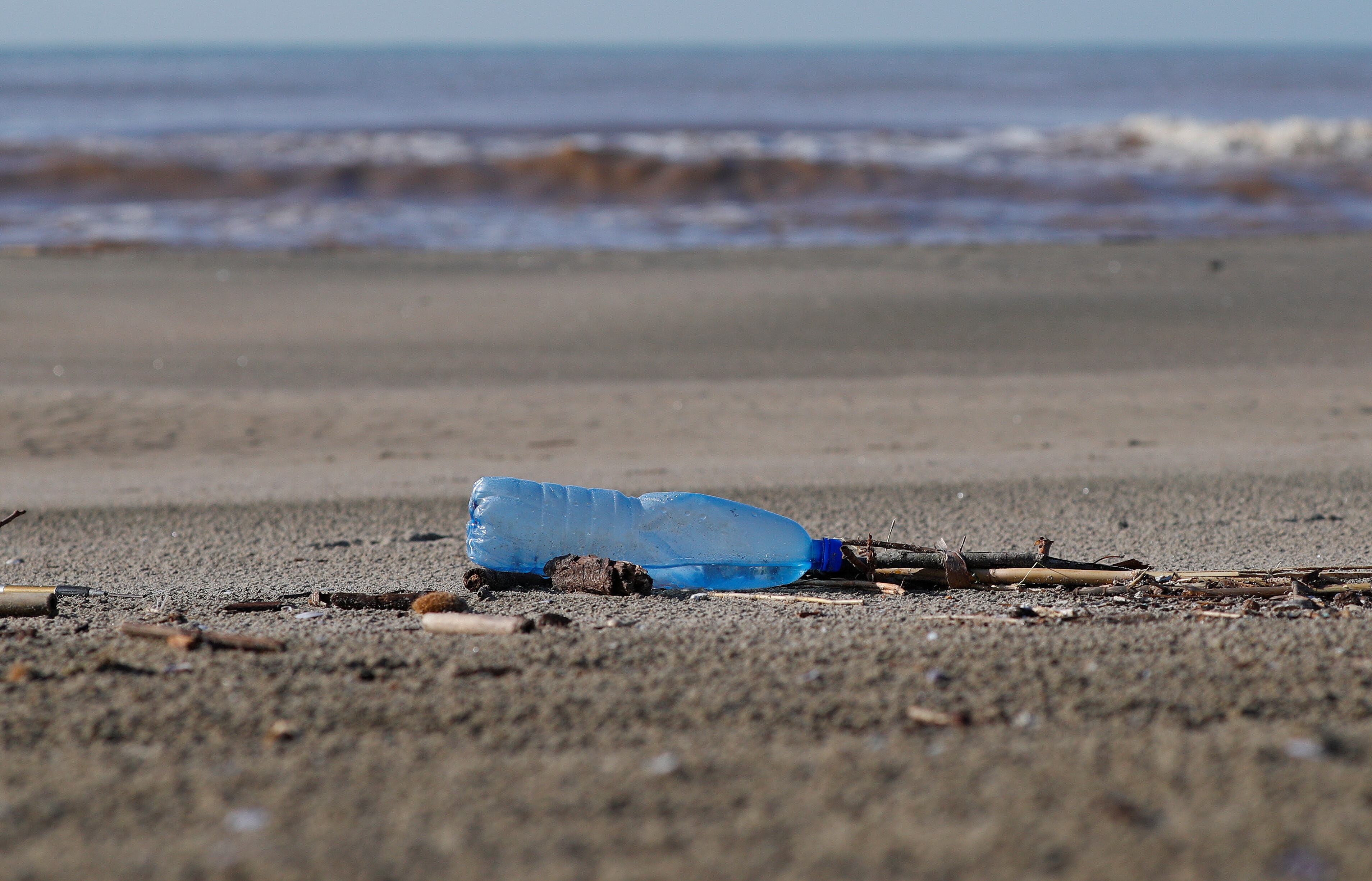 A plastic bottle lies on the sand at Maccarese beach, west of Rome, Italy.