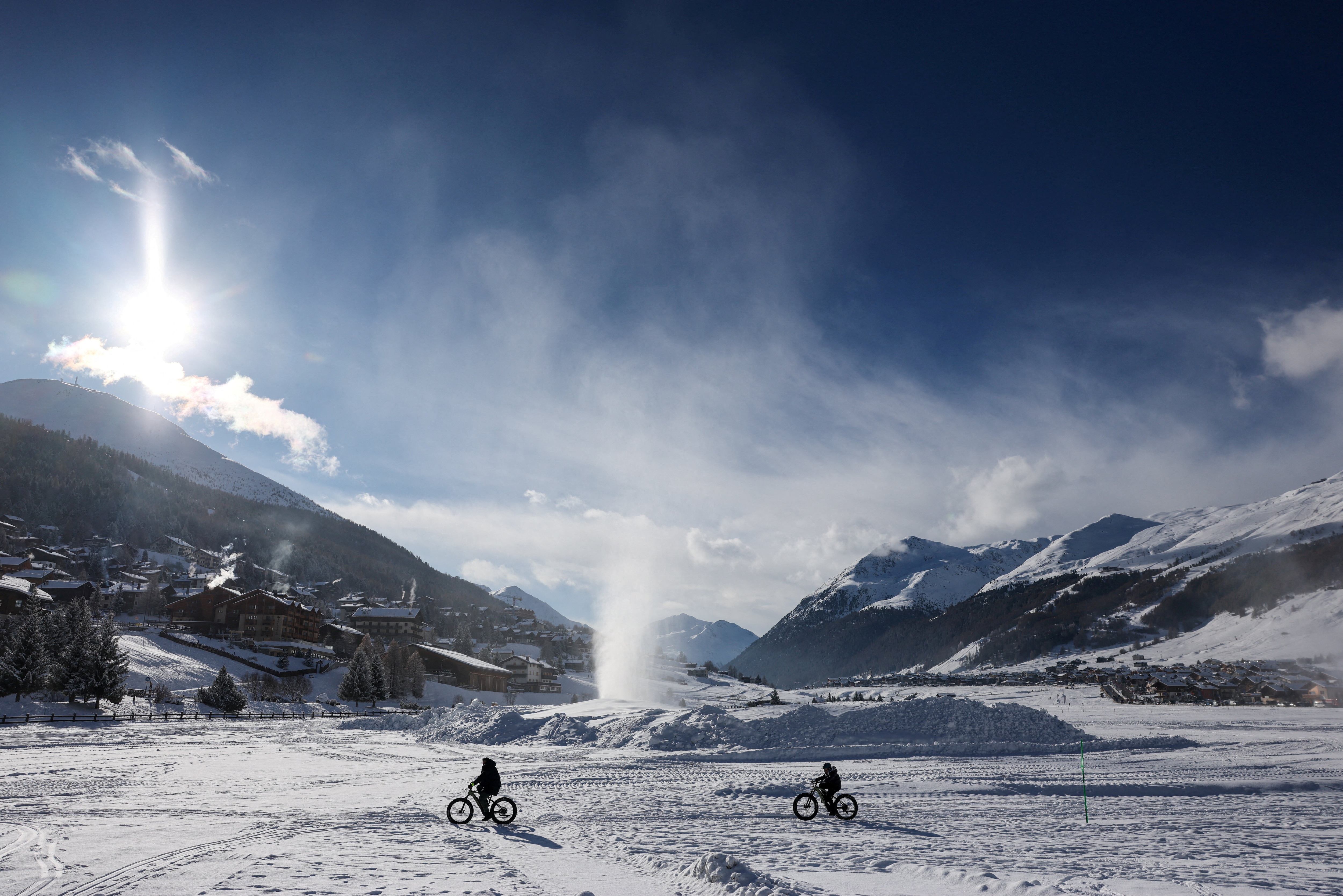 A snow-covered field as artificial snow rises from a snowmaking cannon ahead of Milan Cortina Winter Olympics, in Livigno, Italy, January 9, 2026. 