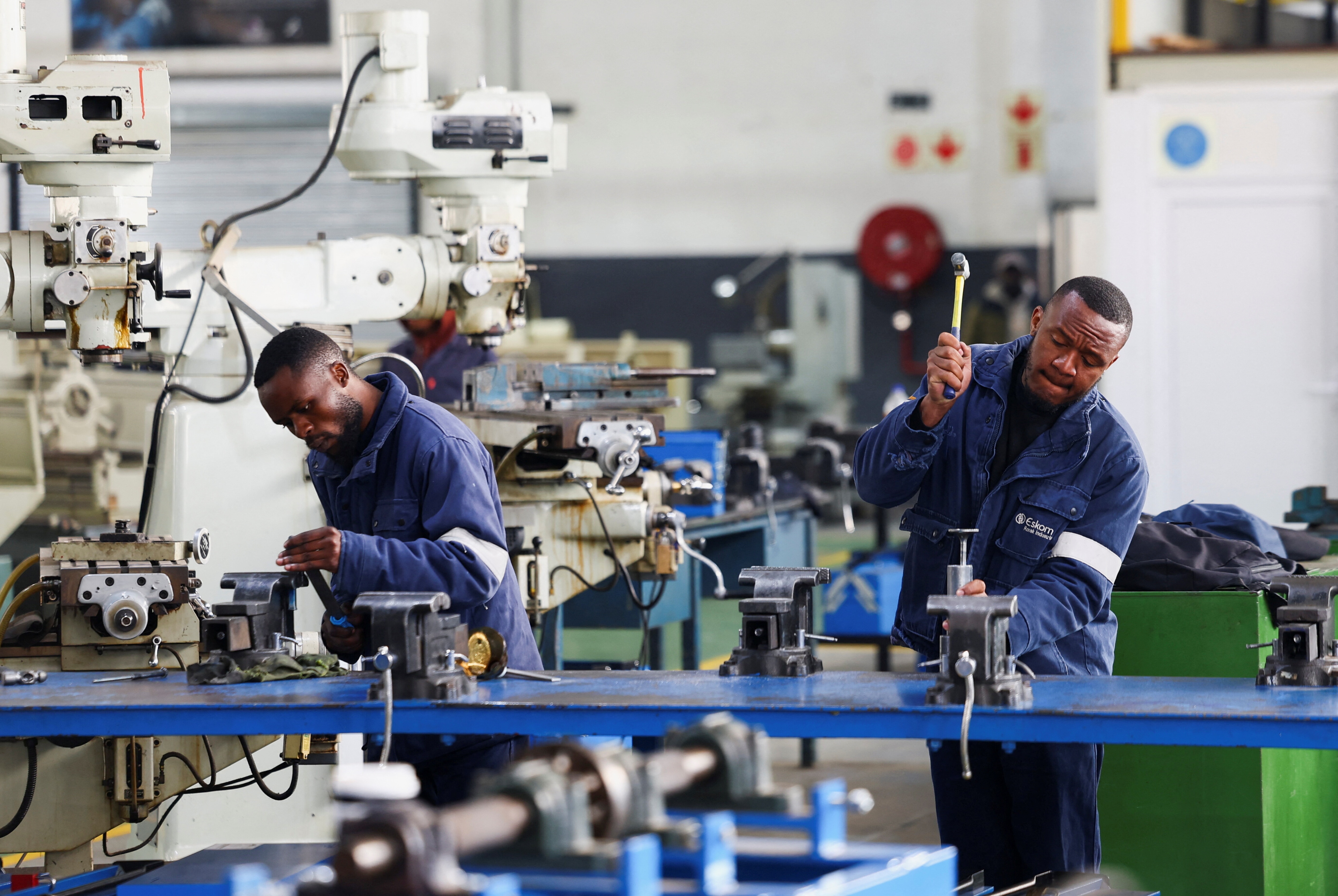 Workers at the Steel and Engineering Industries Federation of Southern Africa (SEIFSA) work with steel products at the companyâs facility in Benoni, east of Johannesburg, South Africa, July 29, 2025. South Africa is embracing industrial clusters as part of its wider industrial strategy.