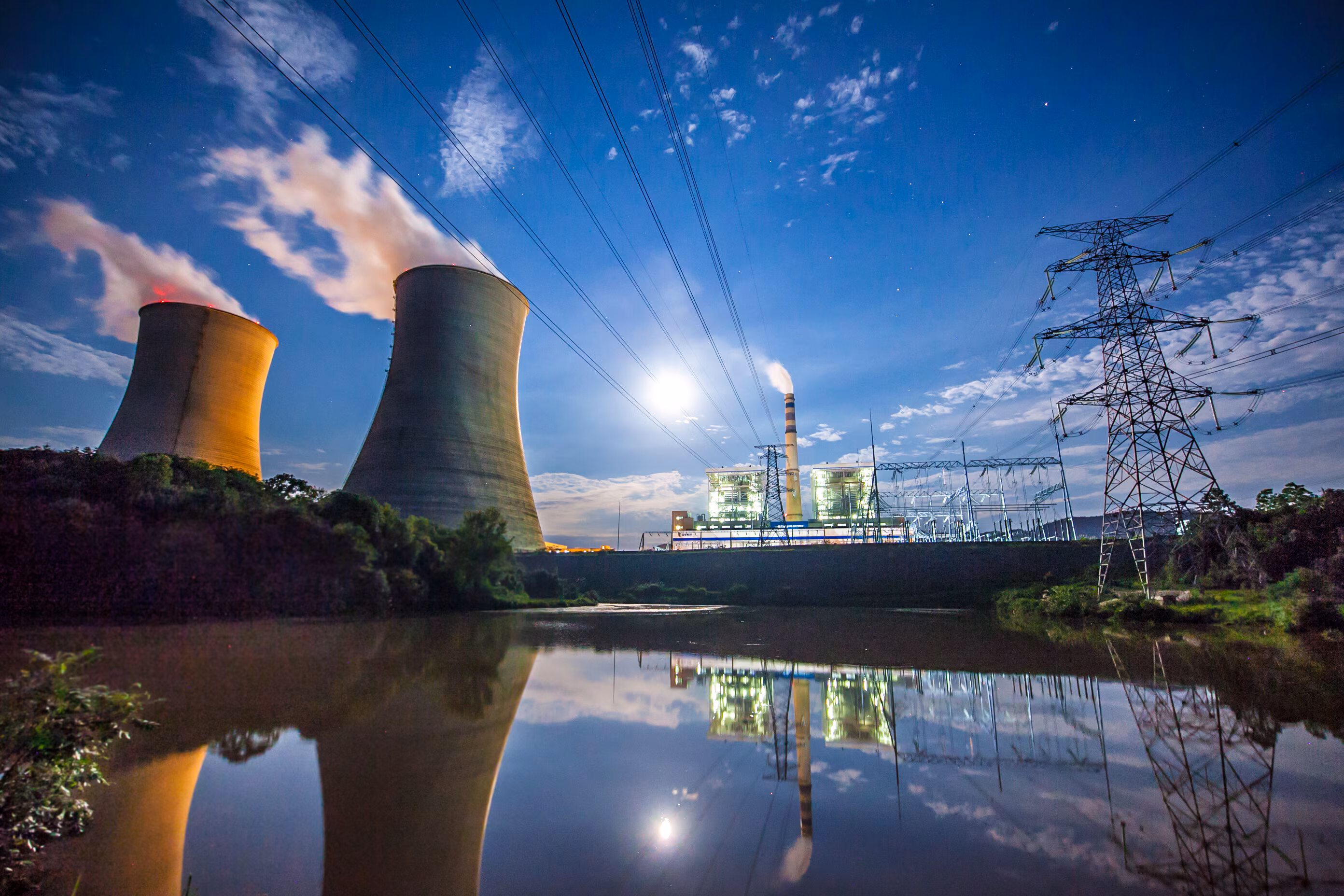 Nuclear reactors and power stations are seen alongside a lake.