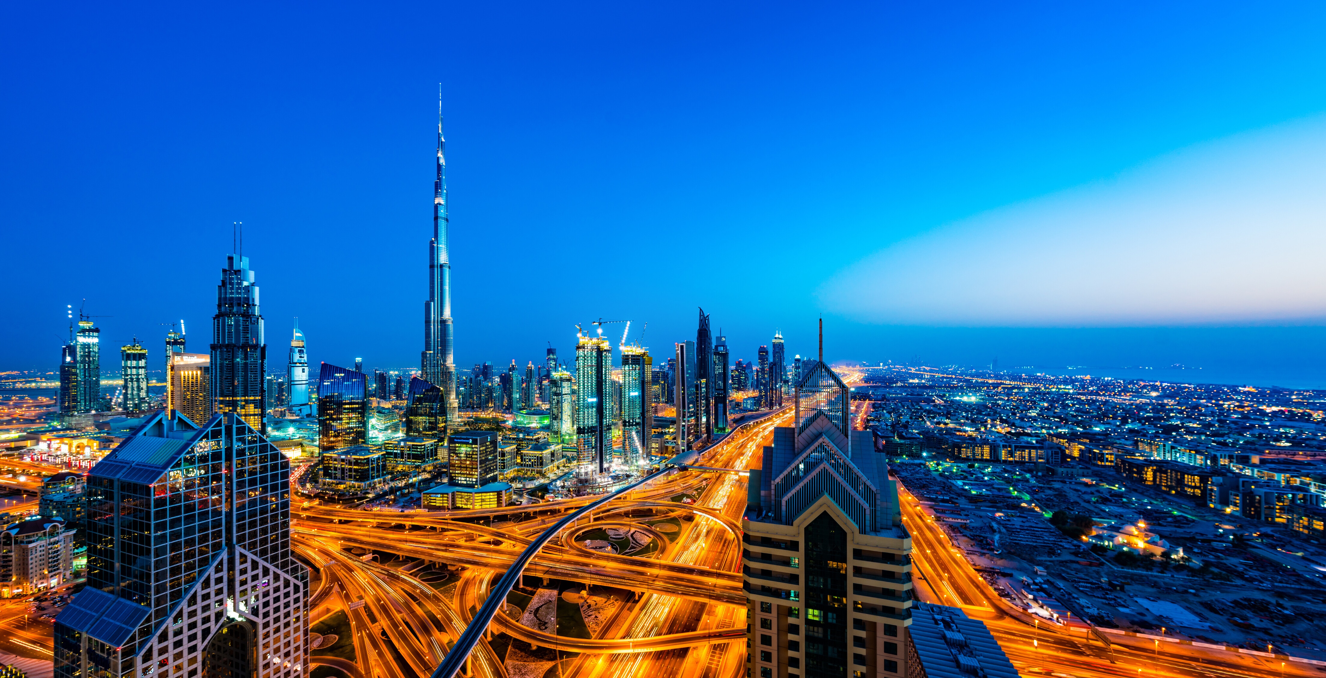 High resolution image of modern skyscrapers with world's tallest building Burj Khalifa (2016/5) in Downtown Dubai, United Arab Emirates at dusk. Dubai is fastest growing city of the world. Large number of tall skyscrapers are built along E11 Sheikh Zayed Road highway with metro line and around futuristic traffic junction. Taken by Sony a7R II, stitched from several photos. Global innovation